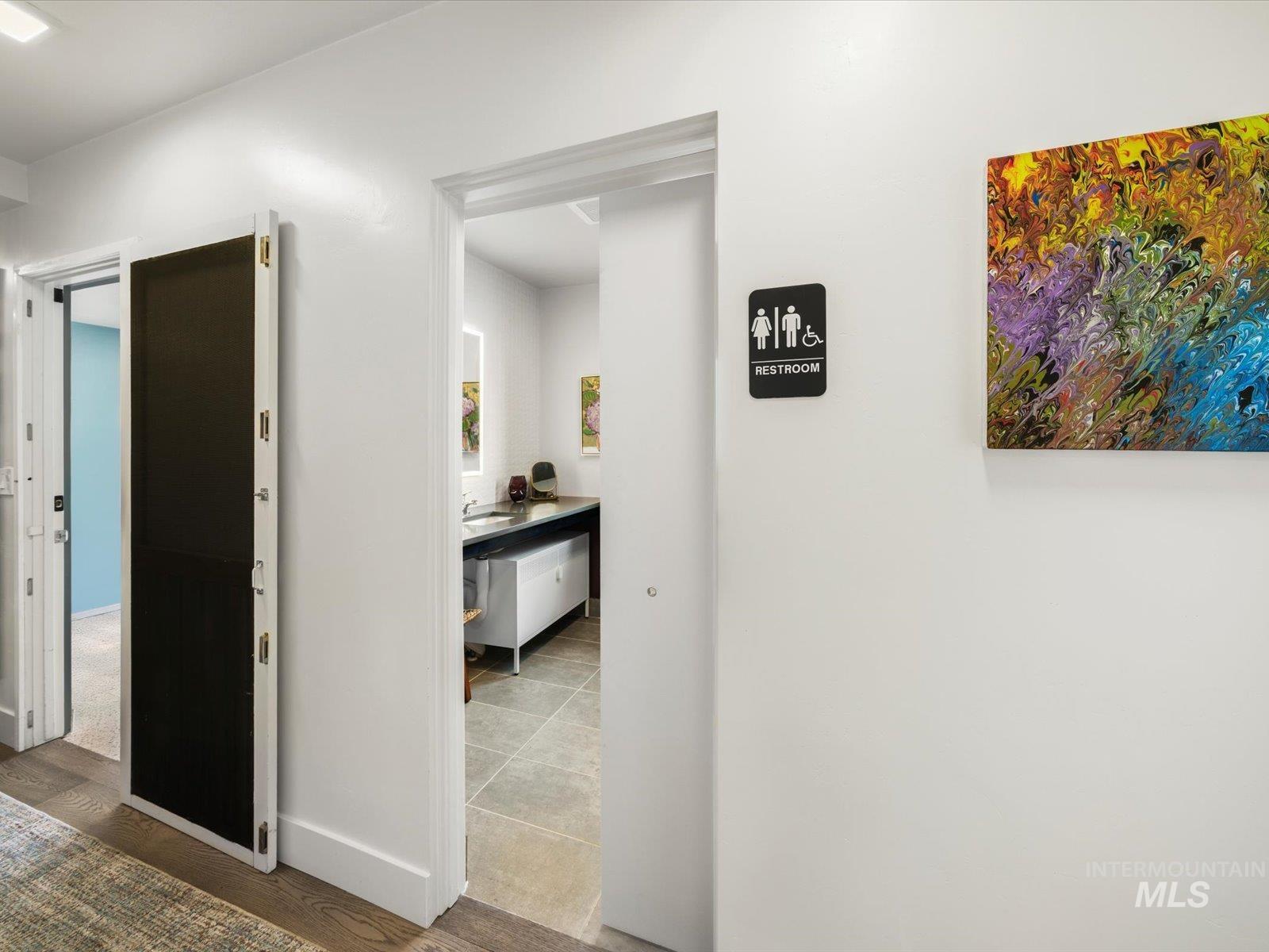 Corridor with wood finished floors and baseboards