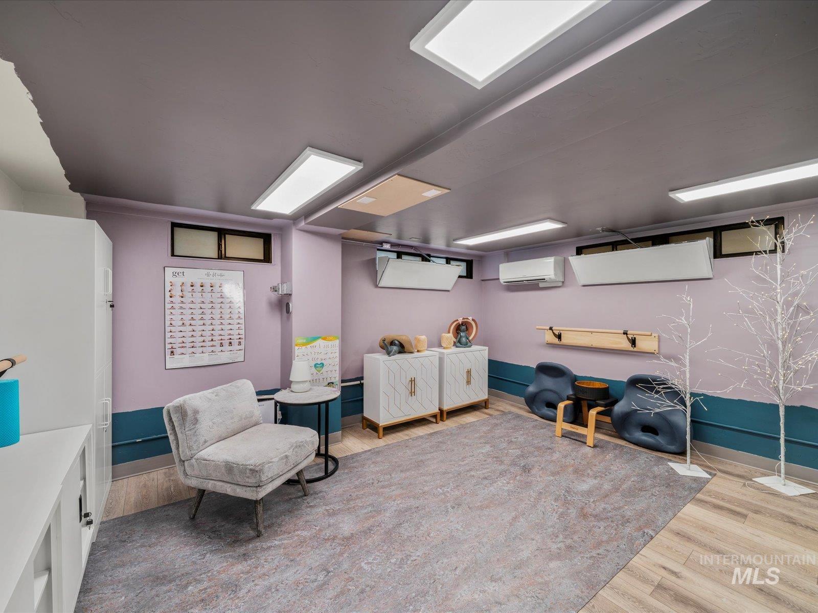 Sitting room with light wood-type flooring and baseboards