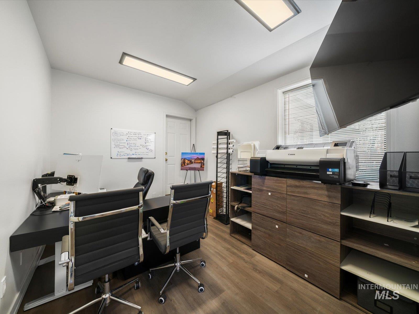 Home office with vaulted ceiling