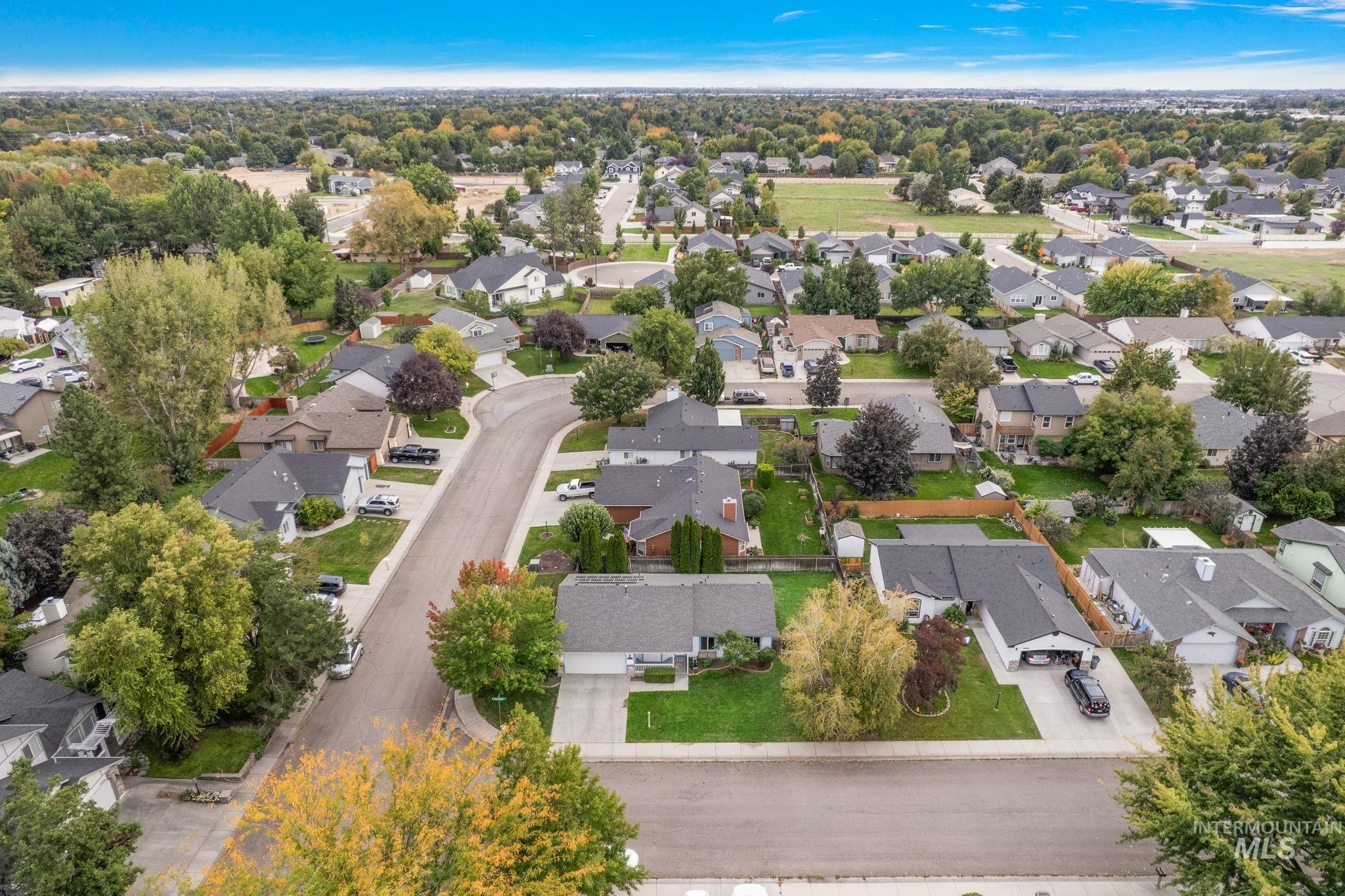 Aerial view of property's location with nearby suburban area