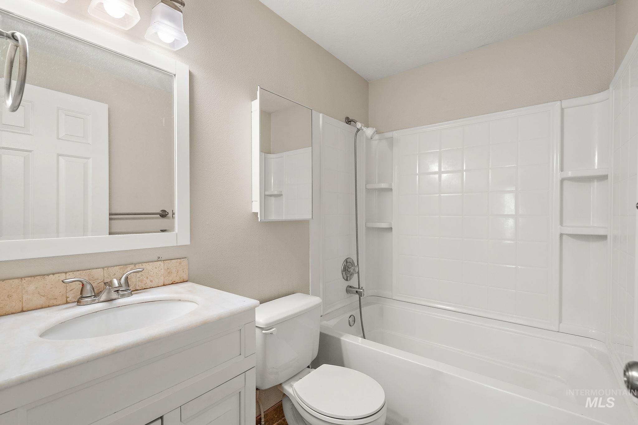 Bathroom featuring bathtub / shower combination and vanity