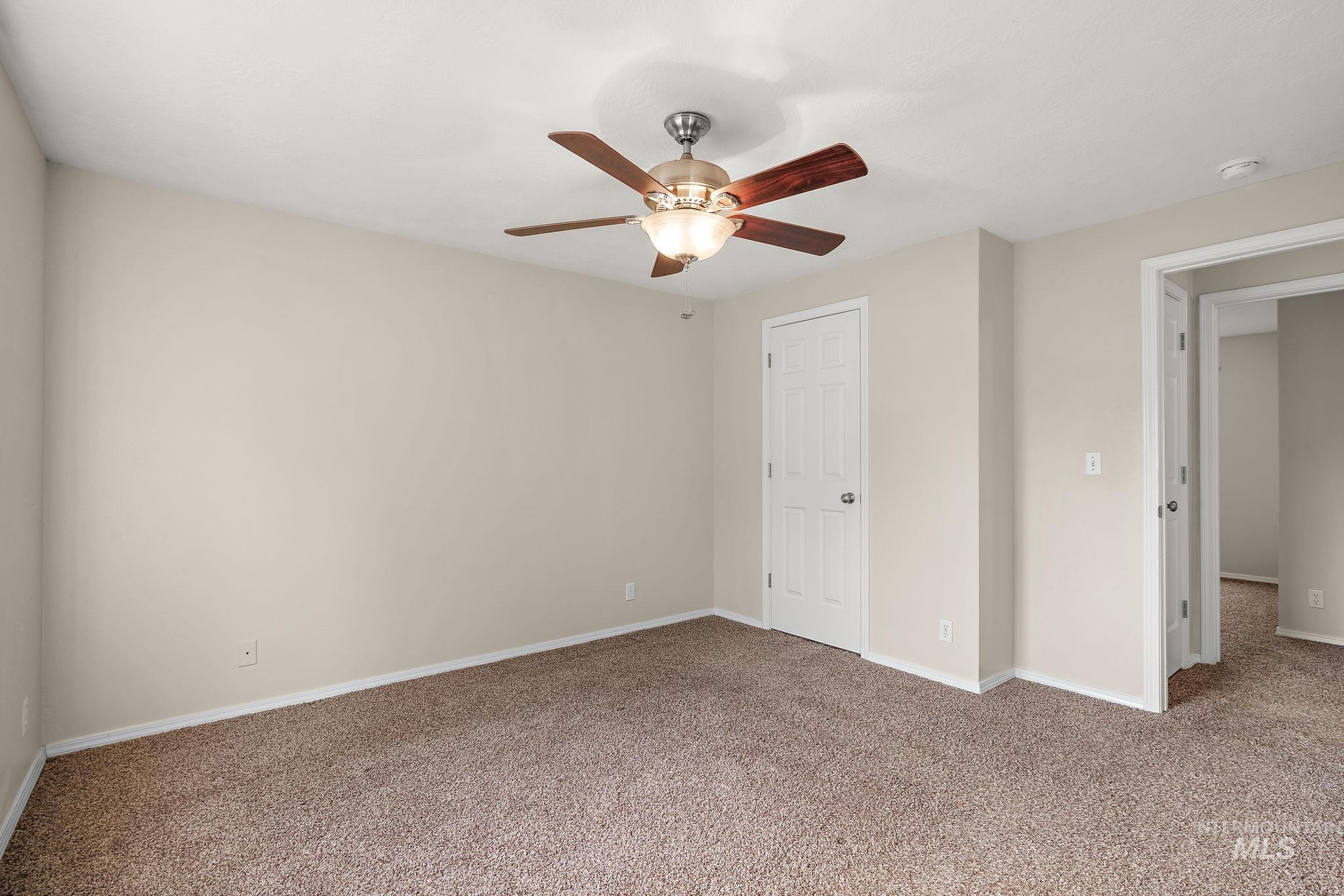 Unfurnished bedroom featuring carpet floors and a ceiling fan