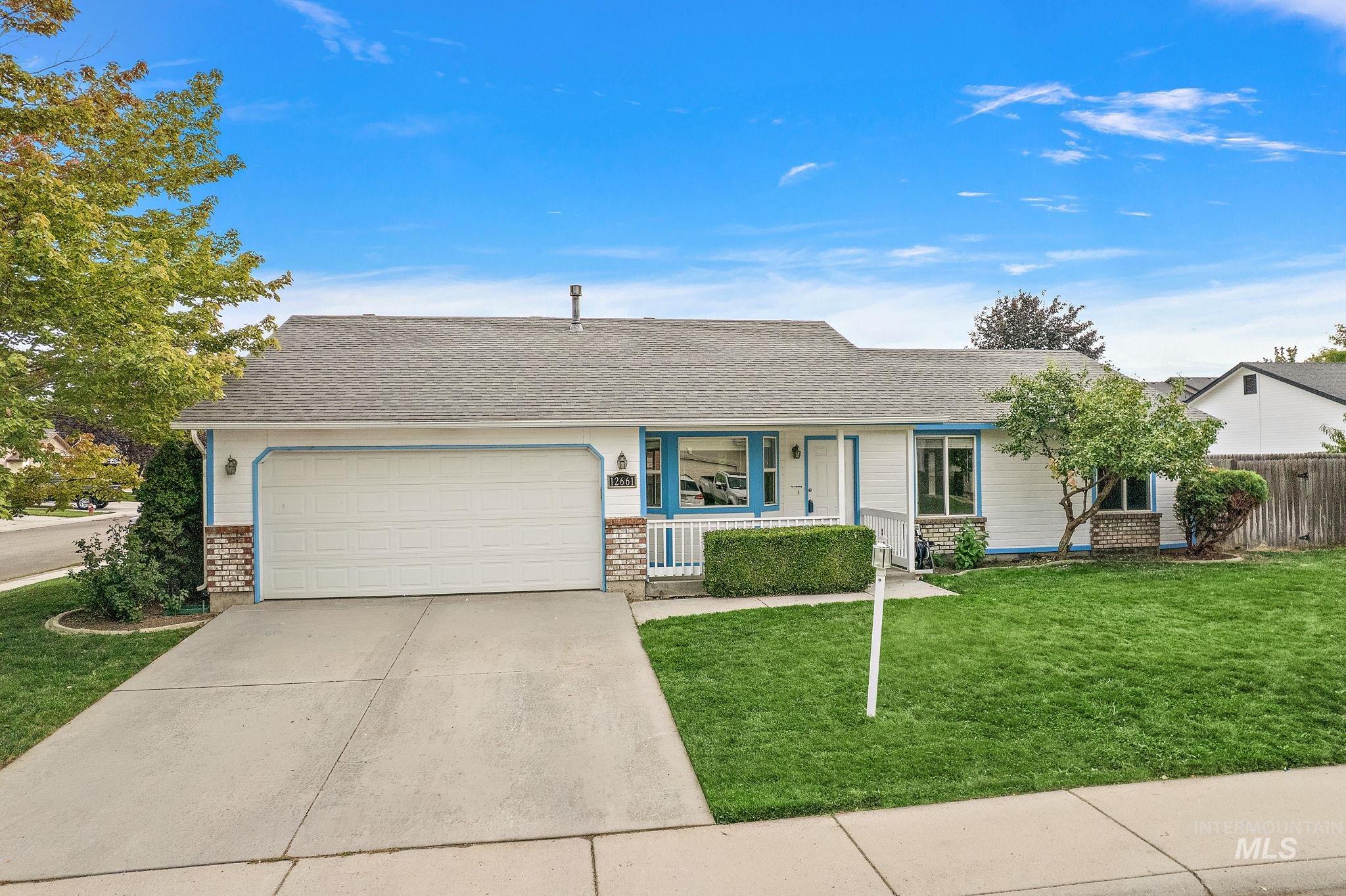 Single story home featuring a front lawn, brick siding, driveway, a garage, and roof with shingles