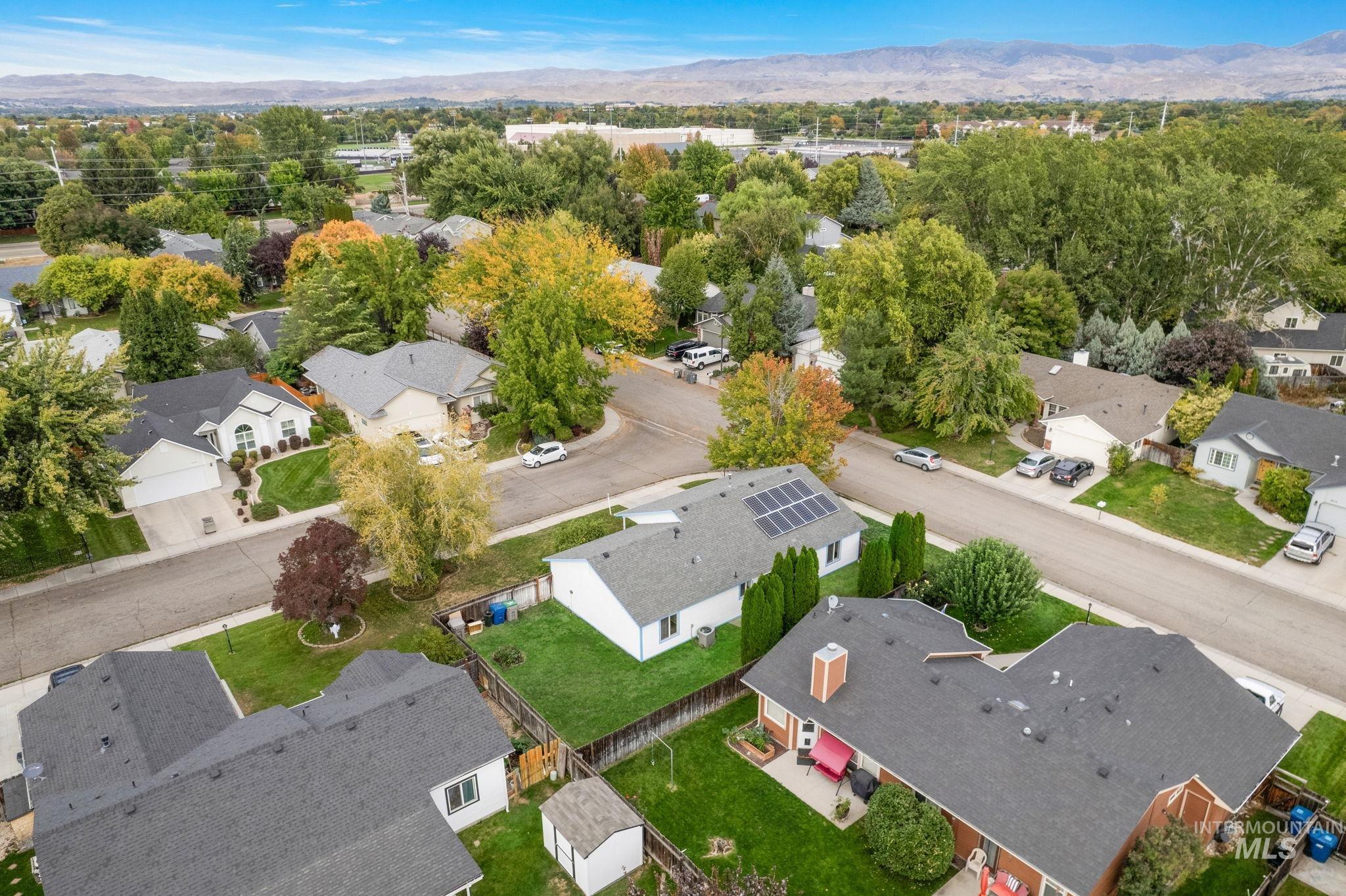 Aerial perspective of suburban area with a mountainous background