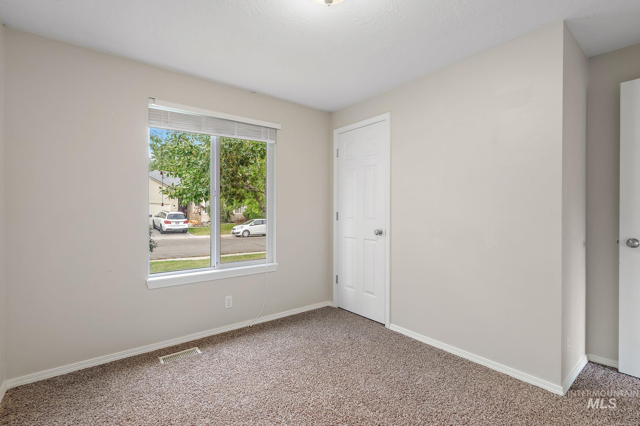 Unfurnished bedroom featuring carpet flooring and baseboards