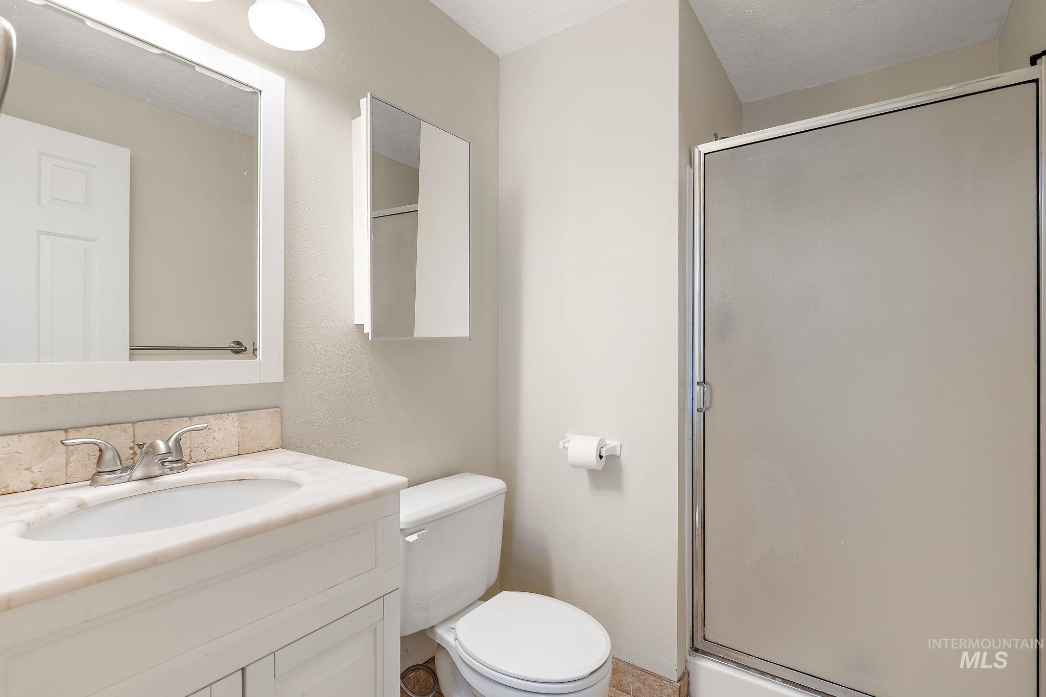 Bathroom with vanity and a stall shower