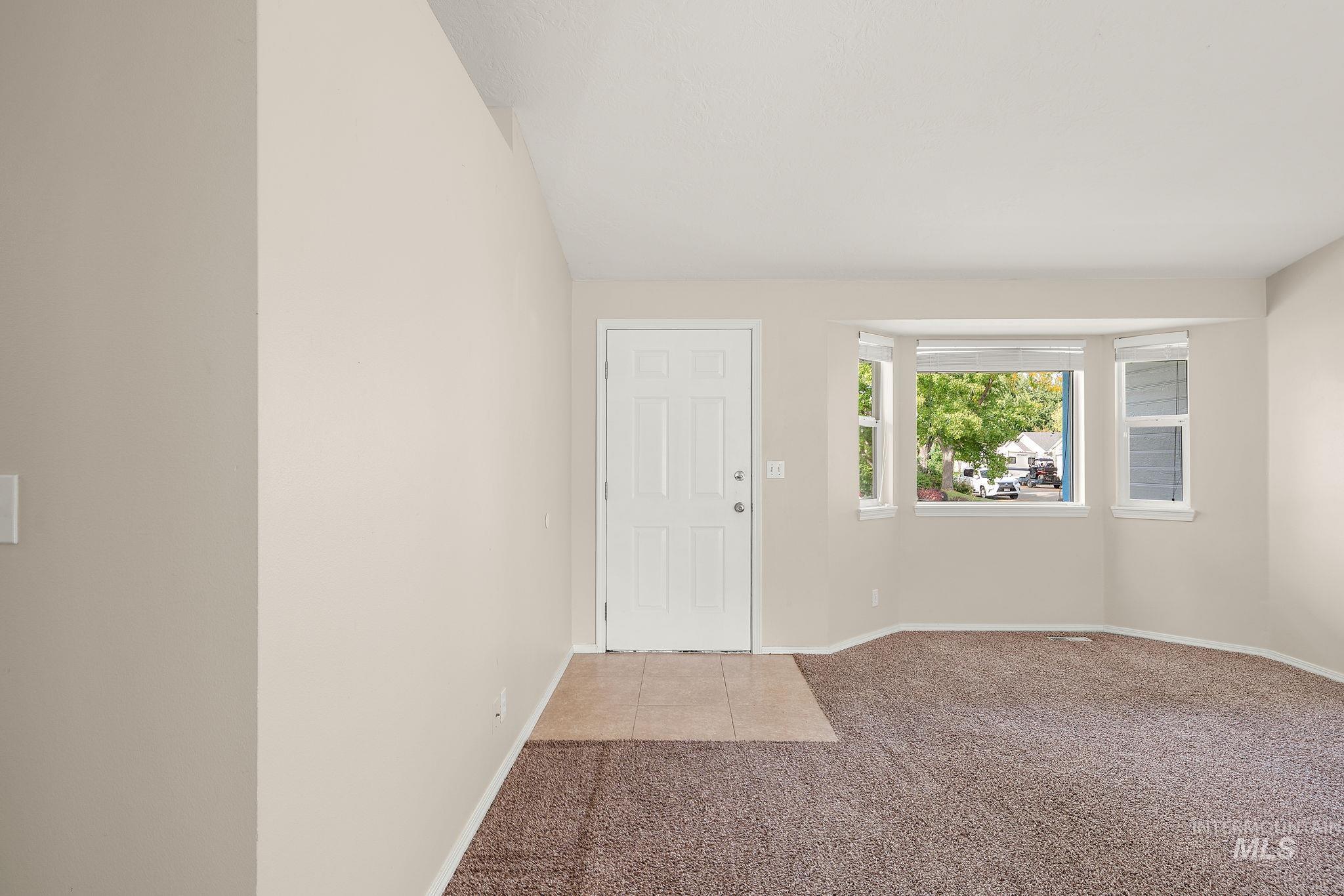 Entryway featuring light carpet and light tile patterned floors