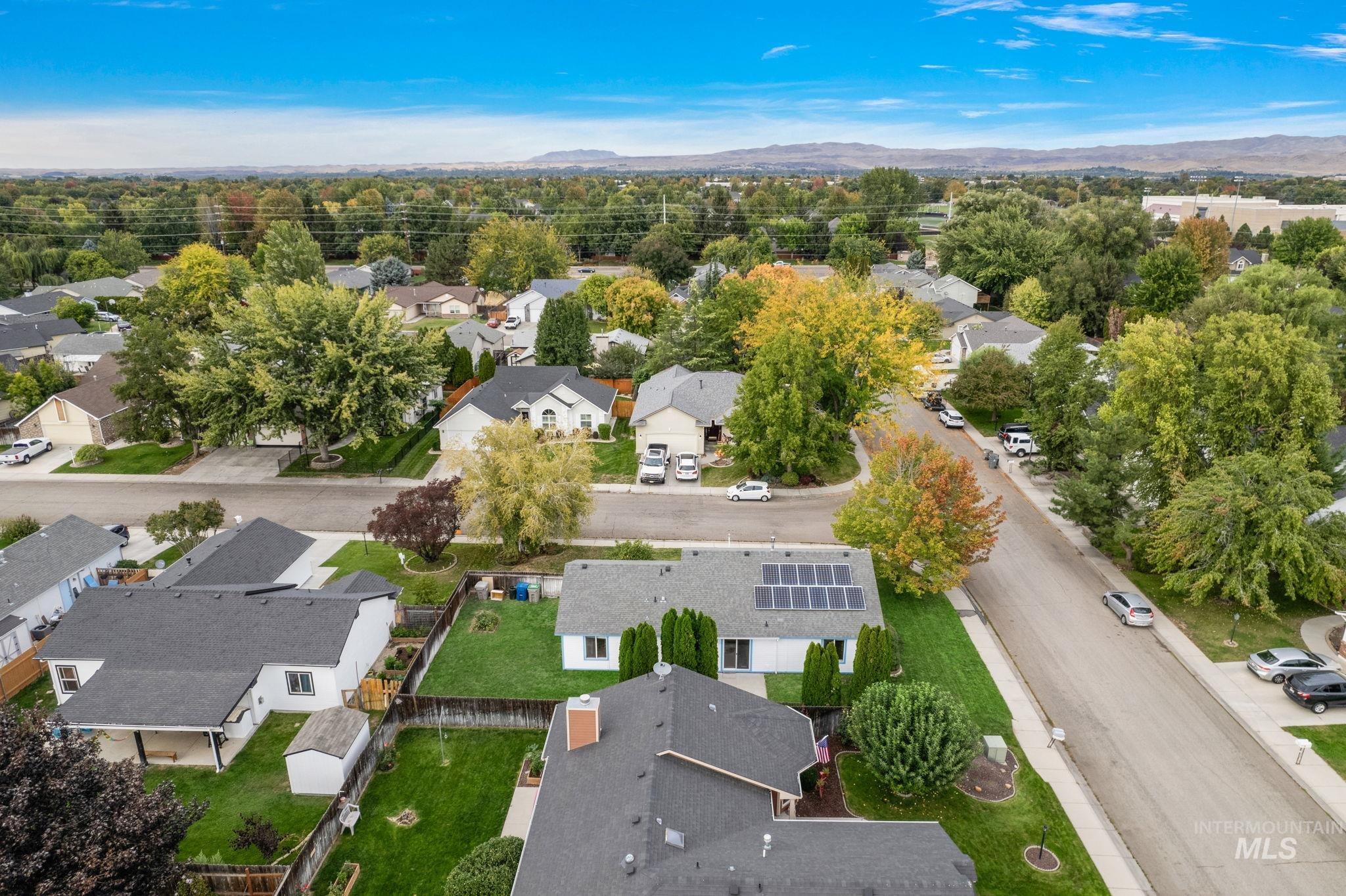 Aerial view of residential area featuring a mountain backdrop