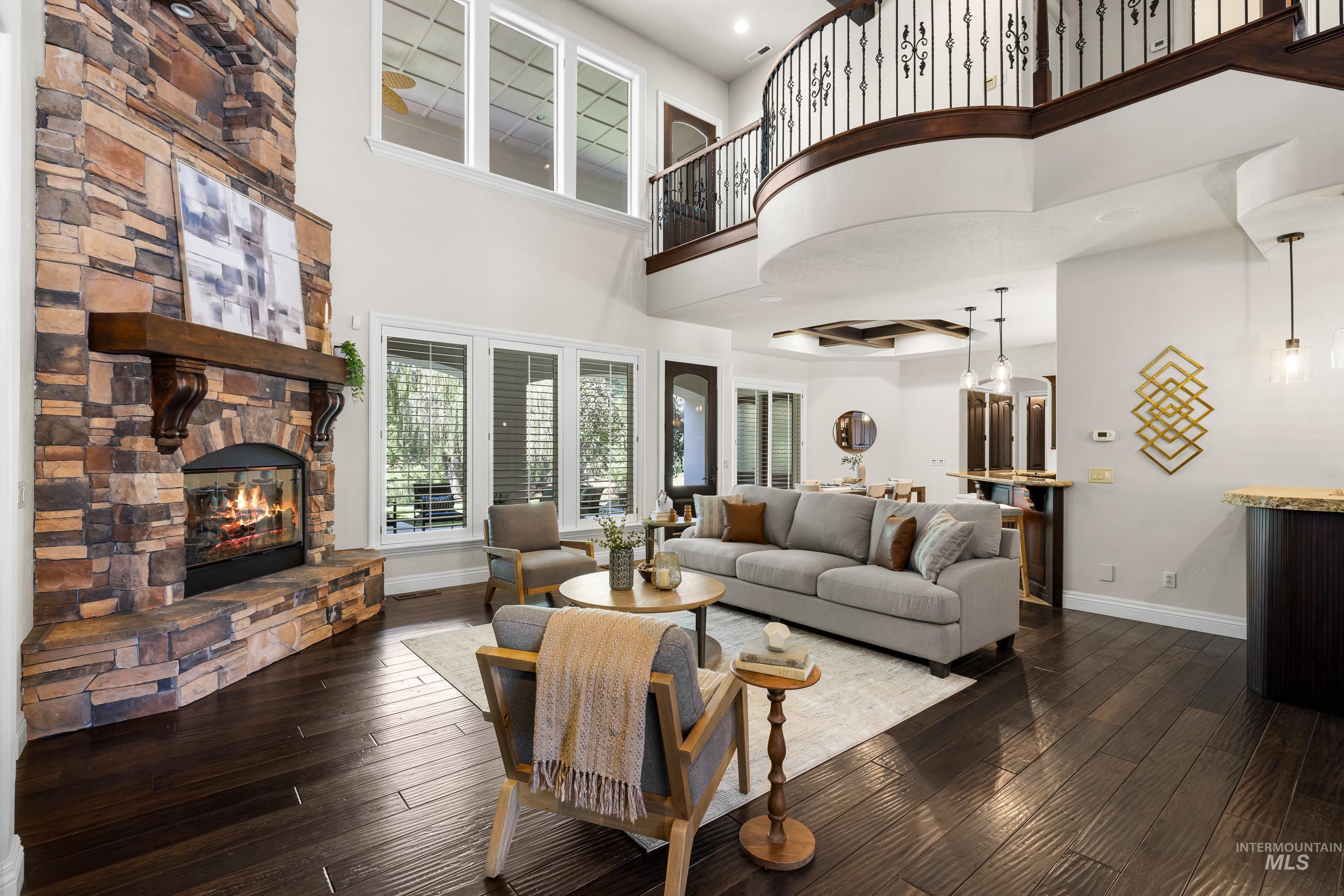 Living area with dark wood-style flooring, a fireplace, and recessed lighting