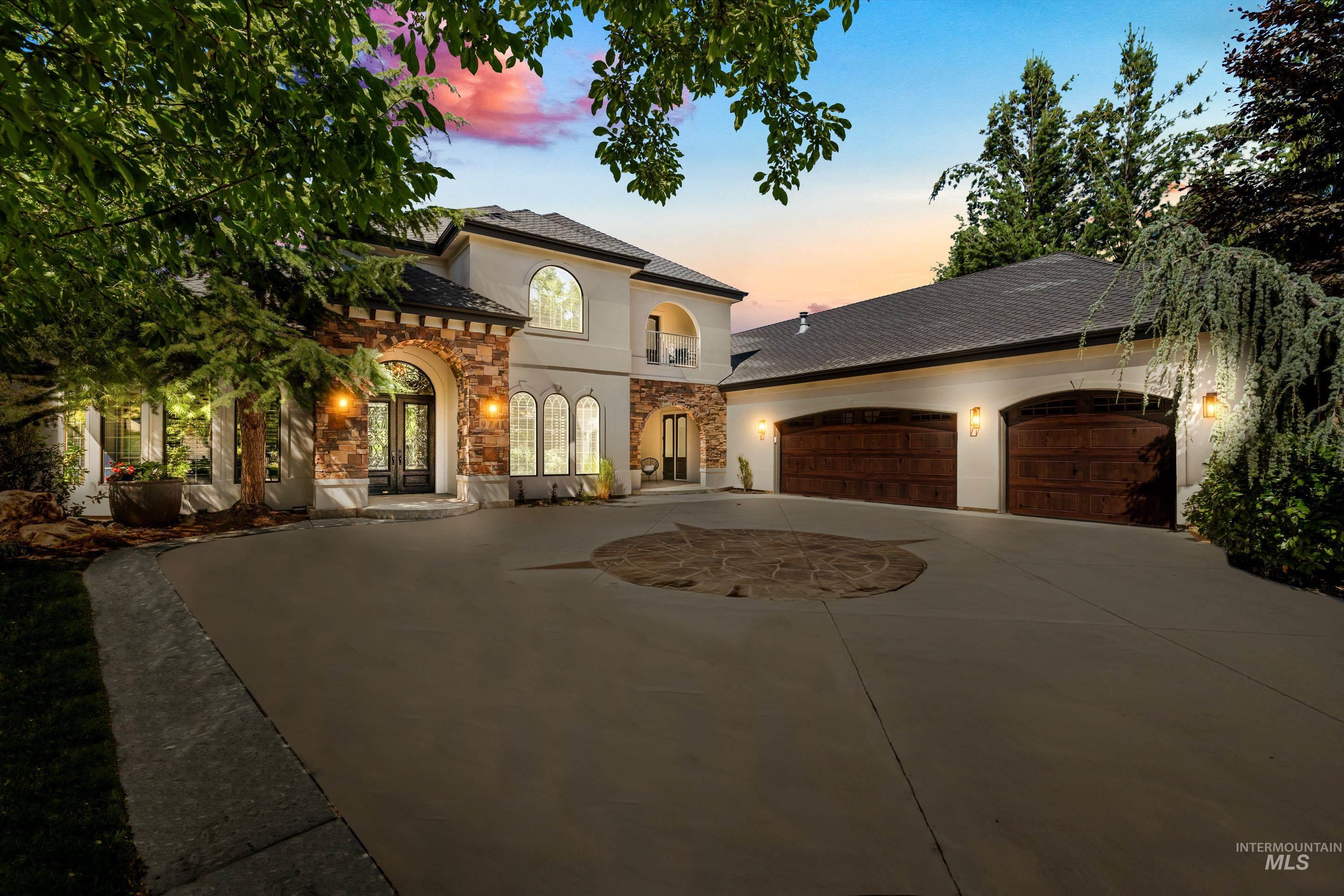 Mediterranean / spanish home with driveway, stucco siding, an attached garage, stone siding, and roof with shingles