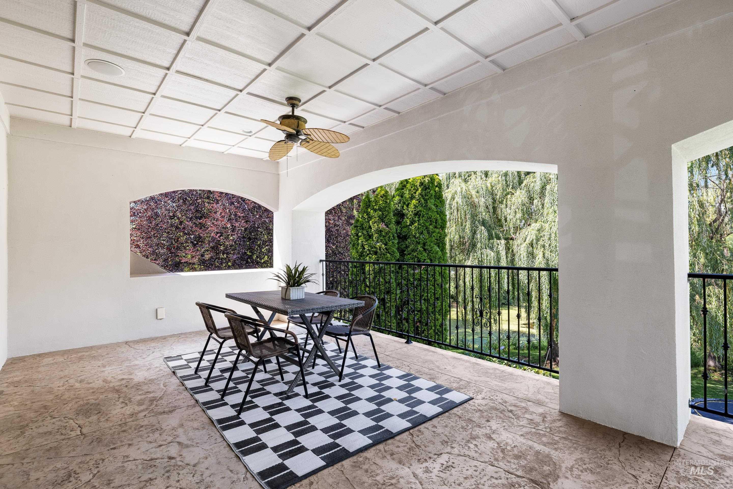 View of patio with a ceiling fan and outdoor dining space