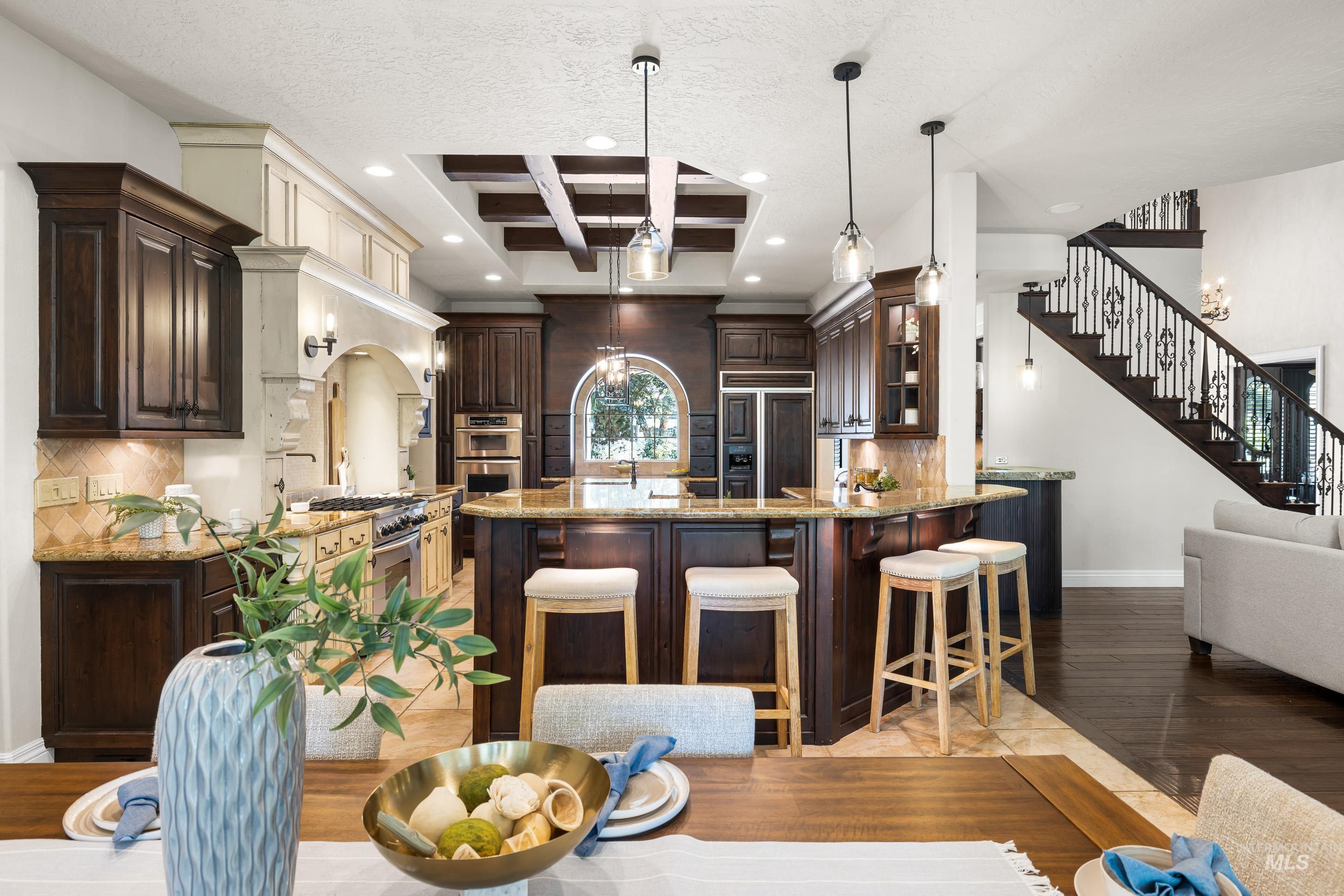 Kitchen featuring tasteful backsplash, dark brown cabinetry, stainless steel appliances, a textured ceiling, and recessed lighting