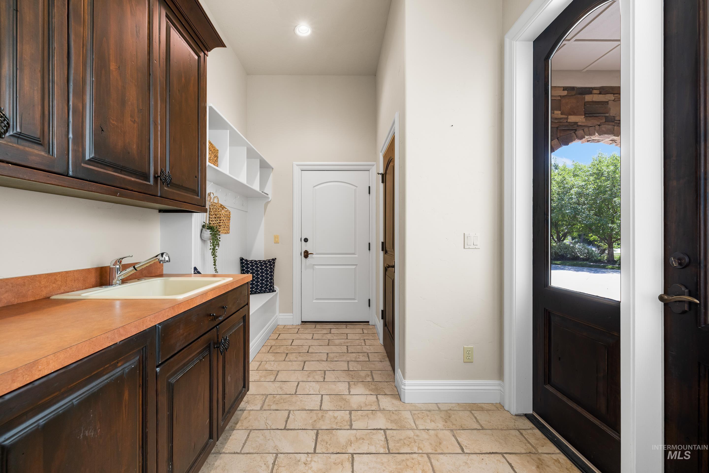 Washroom with baseboards and a sink