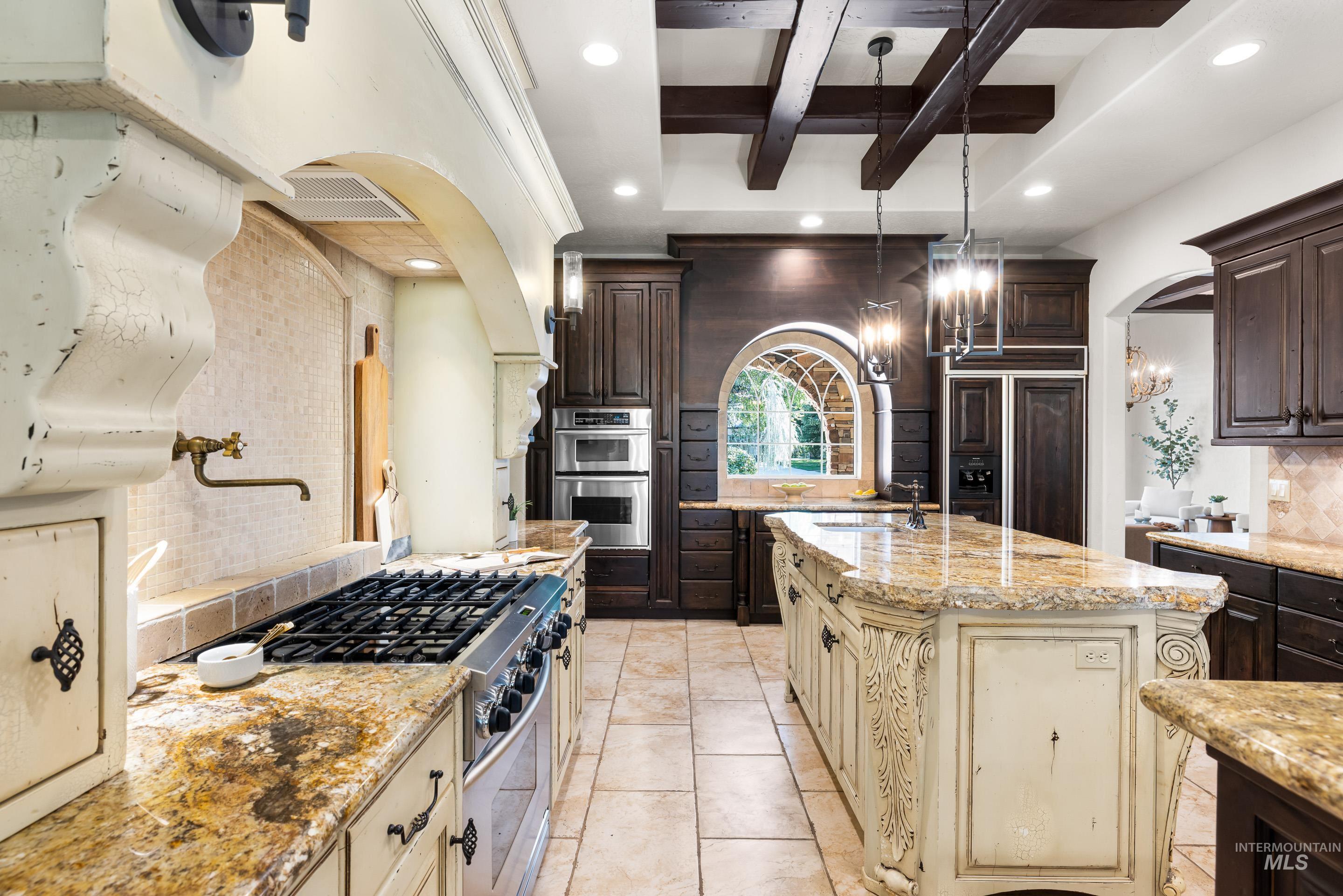 Kitchen with backsplash, recessed lighting, beamed ceiling, dark brown cabinetry, and light stone countertops