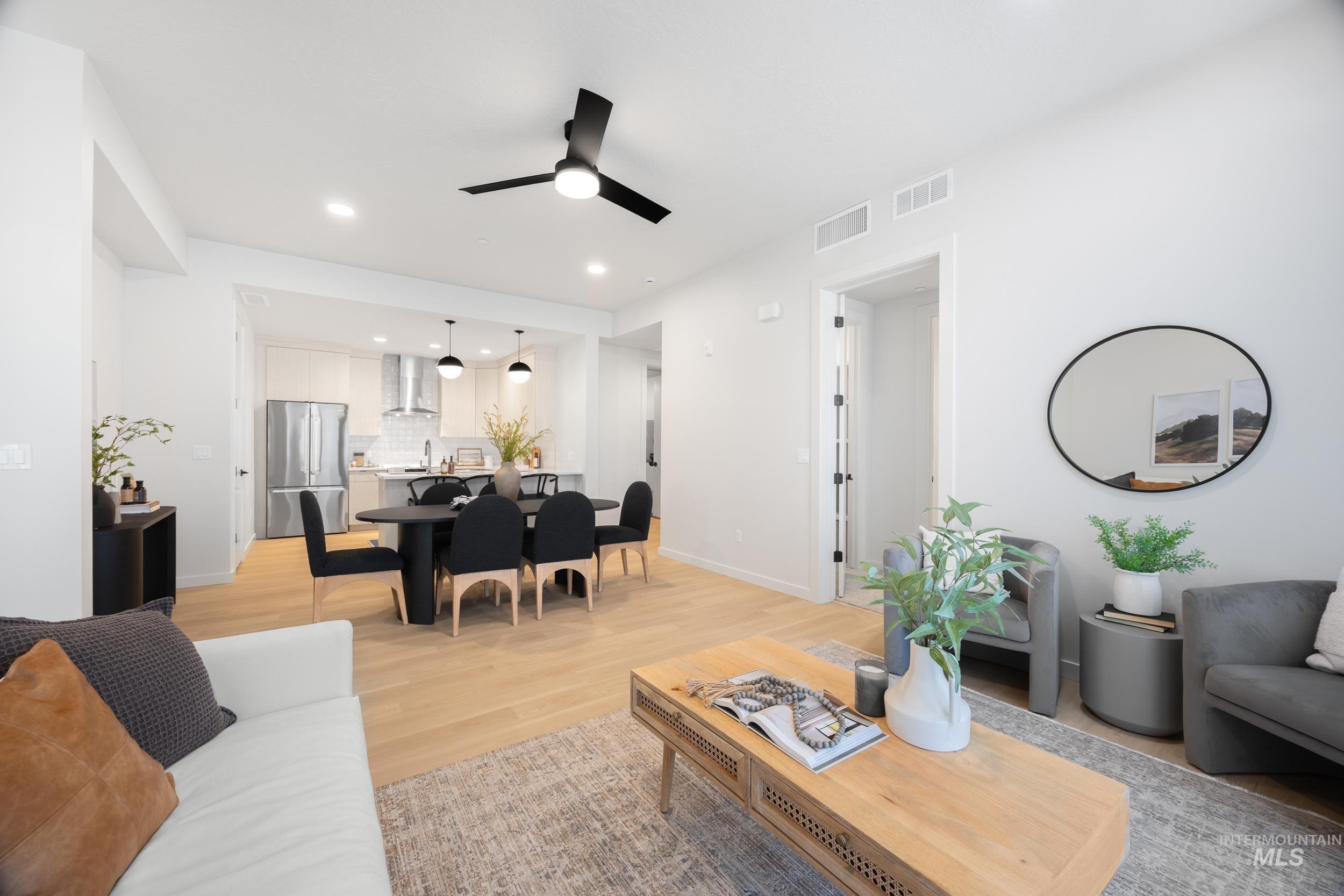 Living area with light wood finished floors, recessed lighting, and ceiling fan