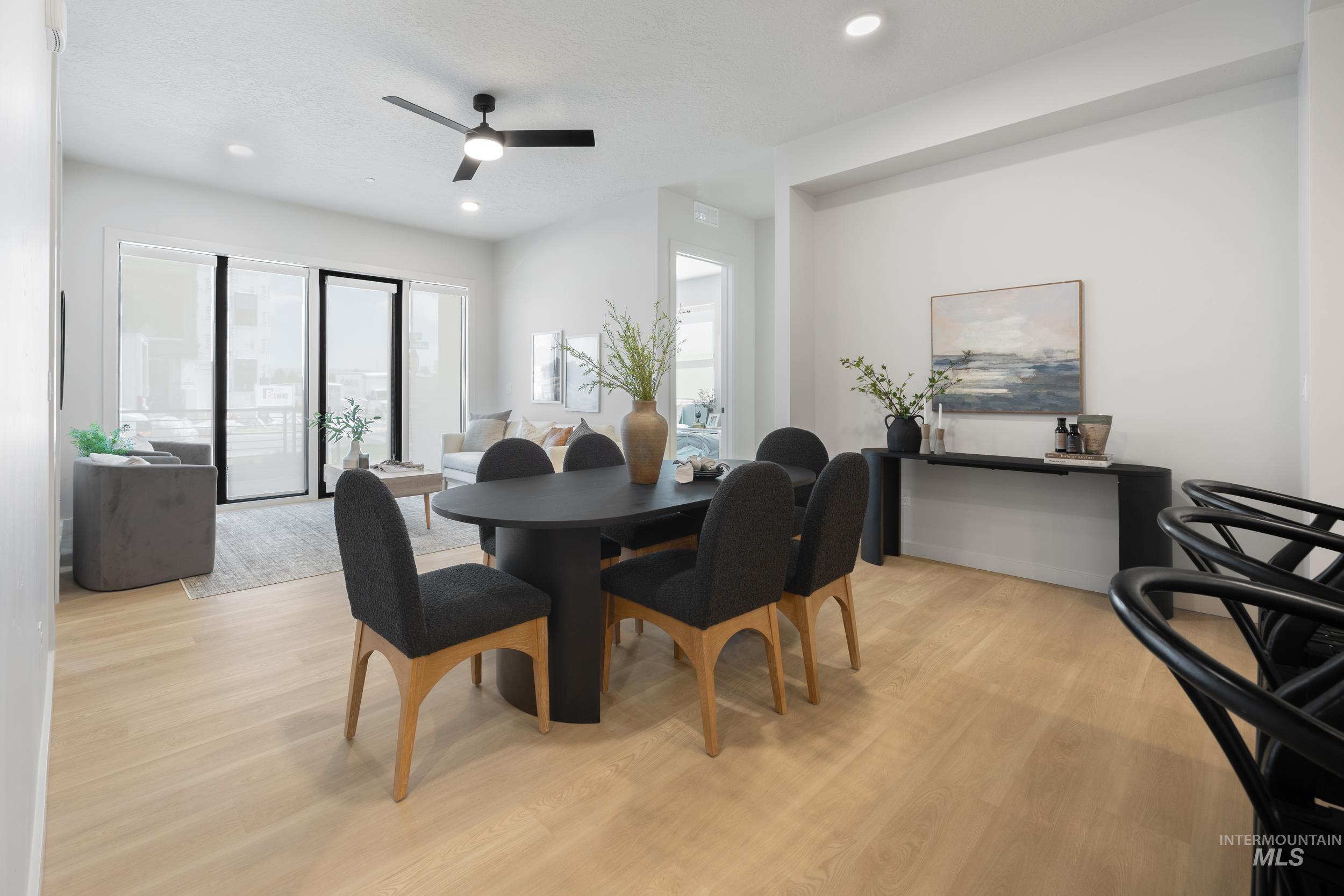 Dining space featuring light wood finished floors, healthy amount of natural light, recessed lighting, and a ceiling fan