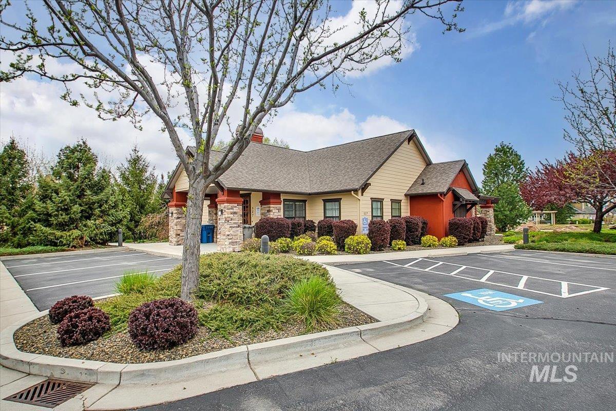 View of property featuring uncovered parking