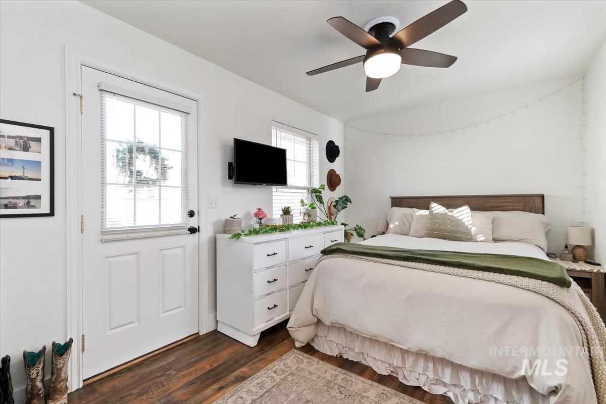 Bedroom with dark wood-style flooring and ceiling fan