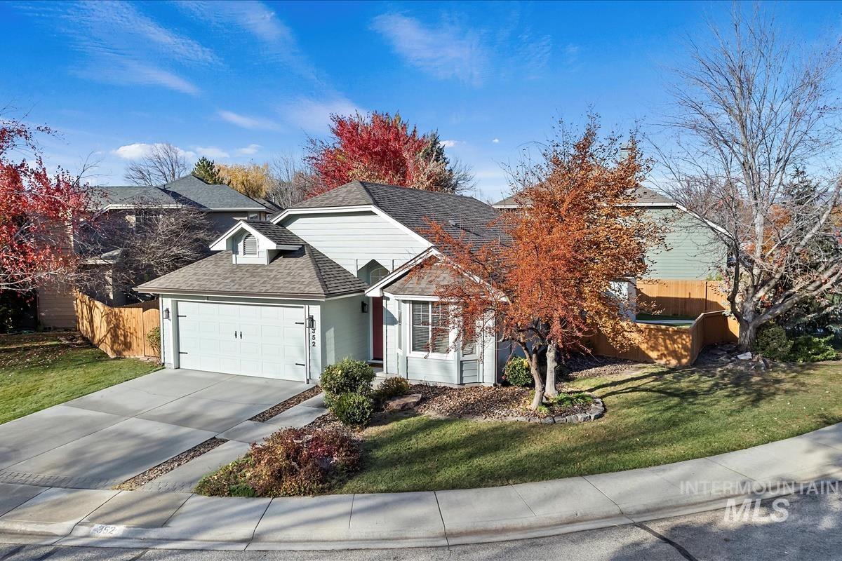 View of front of house featuring roof with shingles, concrete driveway, and a garage
