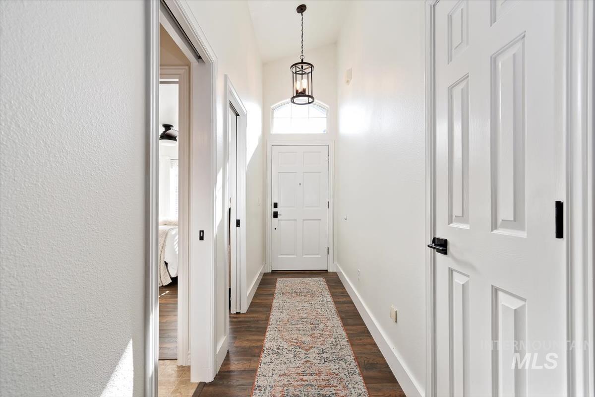 Doorway to outside with wood finished floors and baseboards