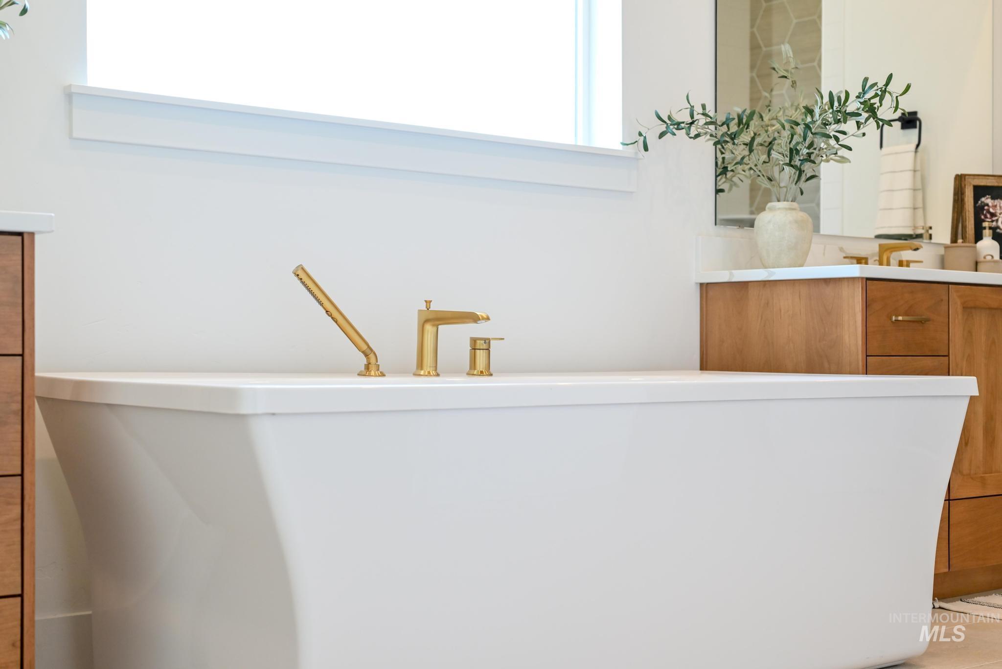 Bathroom view of vanity and a freestanding tub