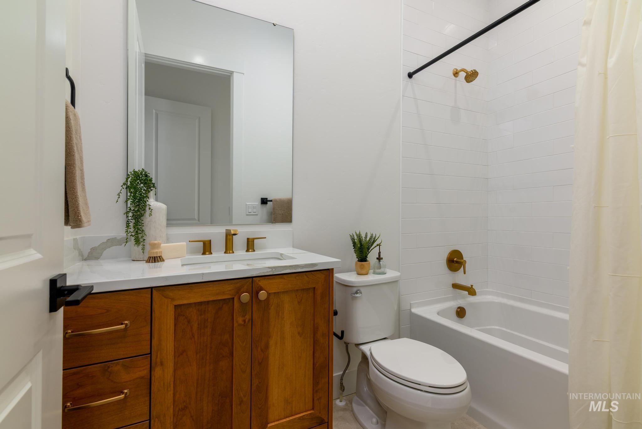 Bathroom featuring shower / tub combo and vanity