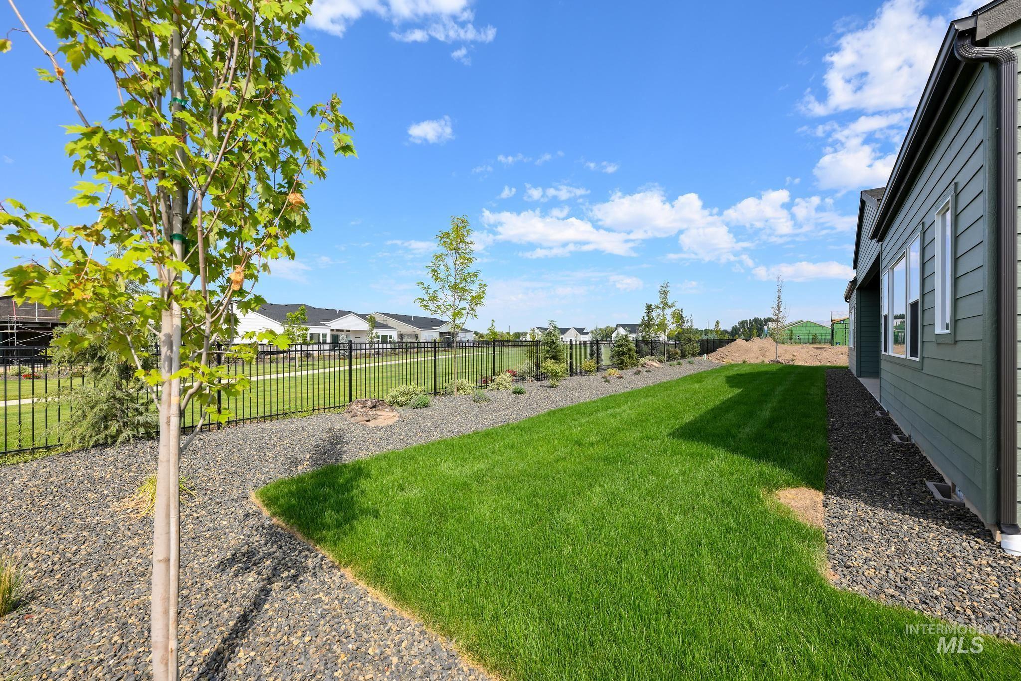Fenced backyard featuring a residential view