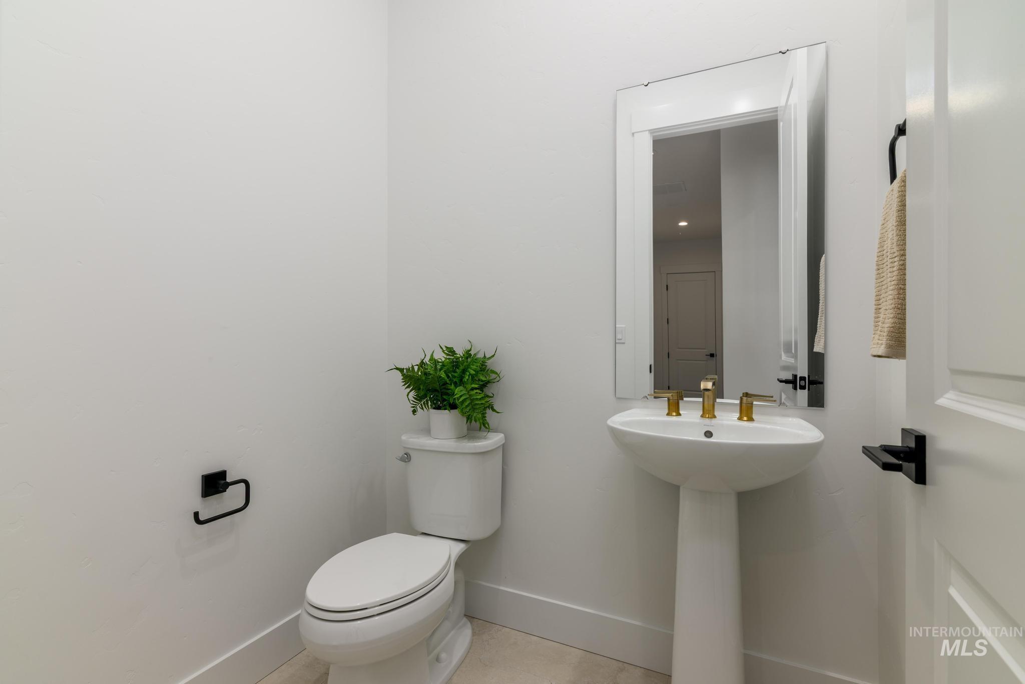 Bathroom featuring baseboards and light tile patterned floors