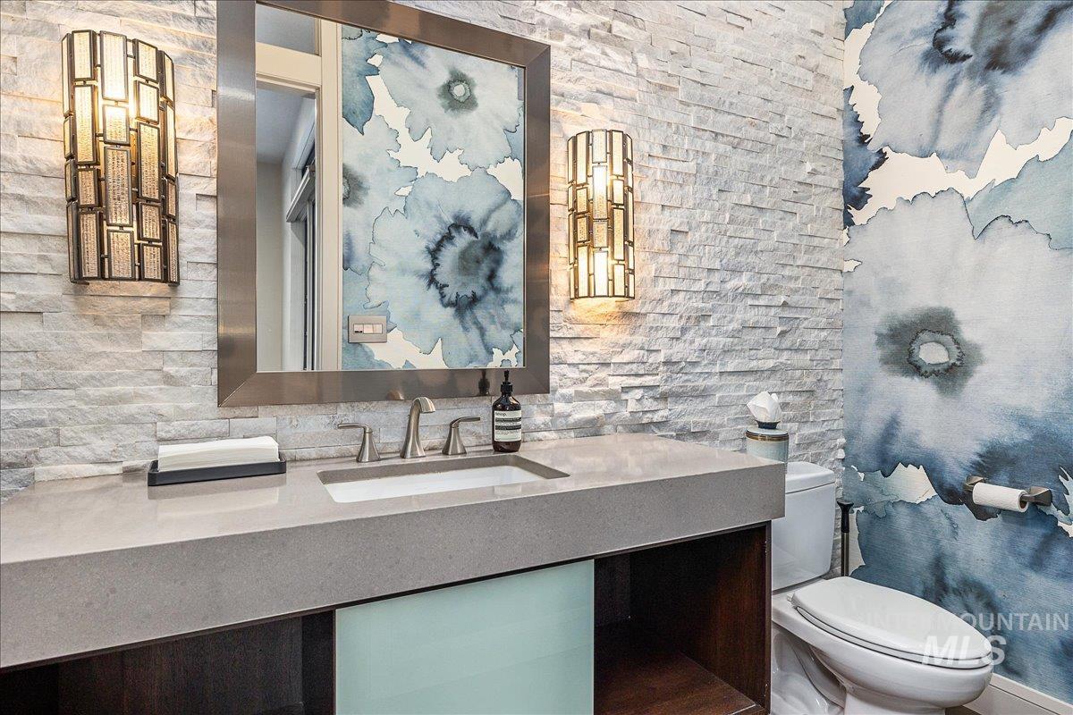 Half bathroom with vanity and toilet