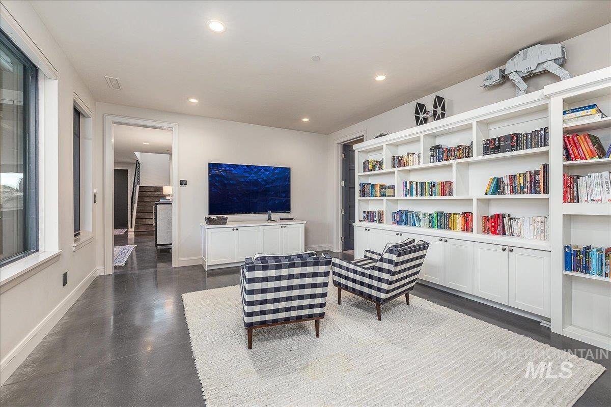 Living area featuring stairs and recessed lighting