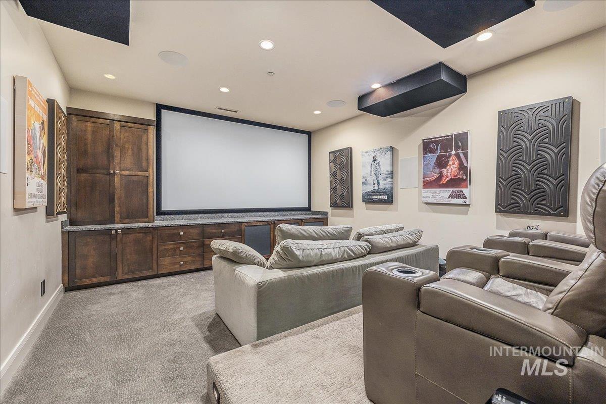 Home theater featuring light carpet and recessed lighting