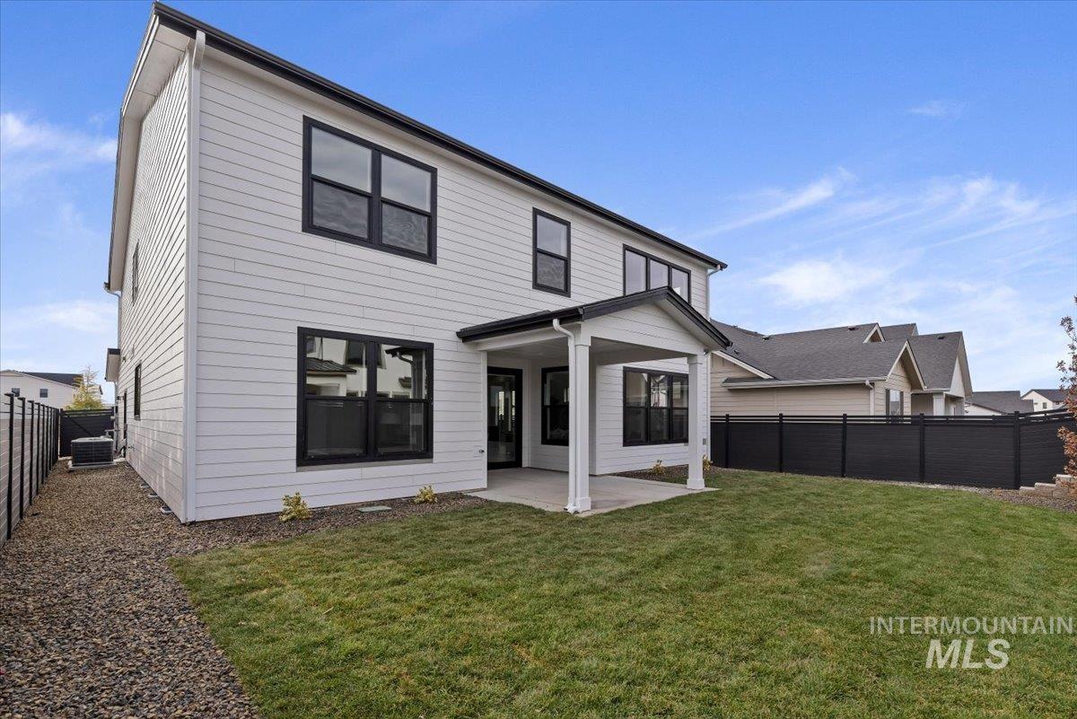 Rear view of property featuring a patio area and a fenced backyard