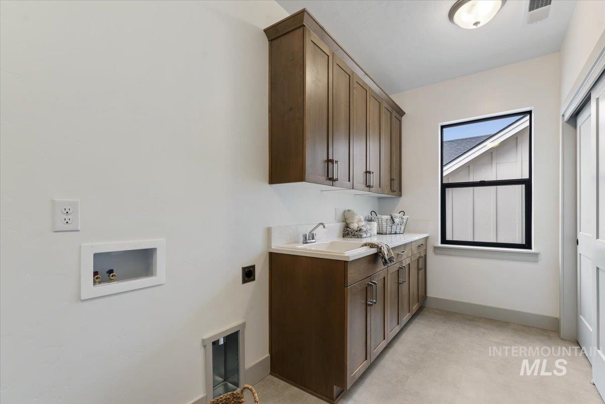 Laundry room featuring cabinet space, washer hookup, and hookup for an electric dryer