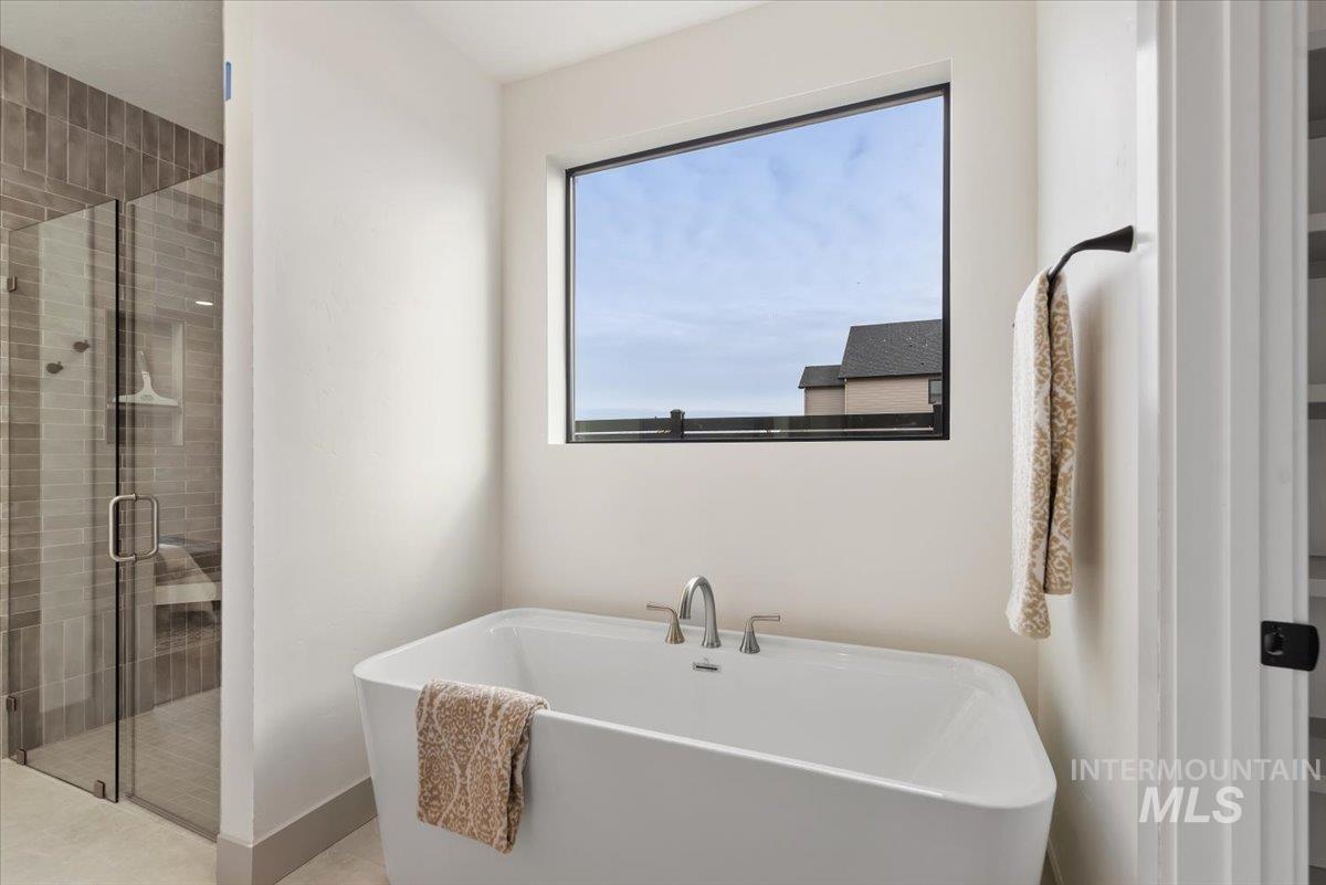 Full bathroom with a stall shower and a freestanding bath