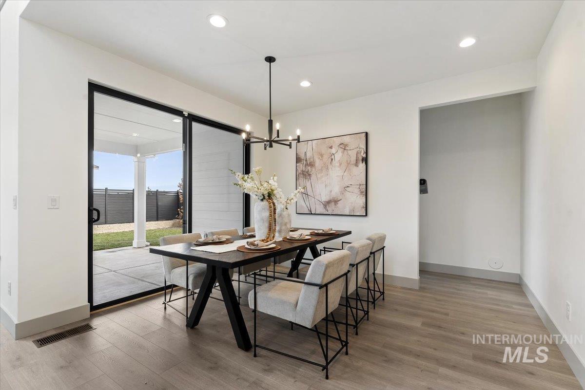 Dining space featuring light wood-style flooring and hanging lights