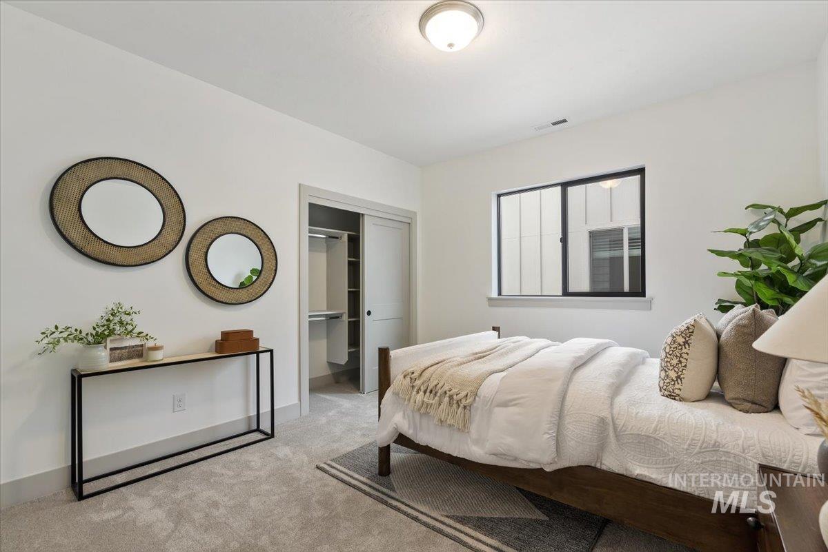 Carpeted bedroom featuring baseboards
