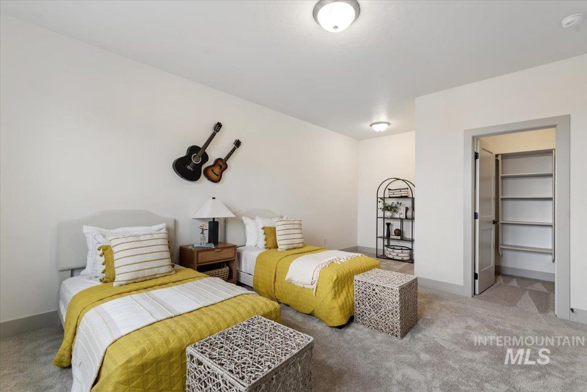 Bedroom with carpet floors and a spacious closet