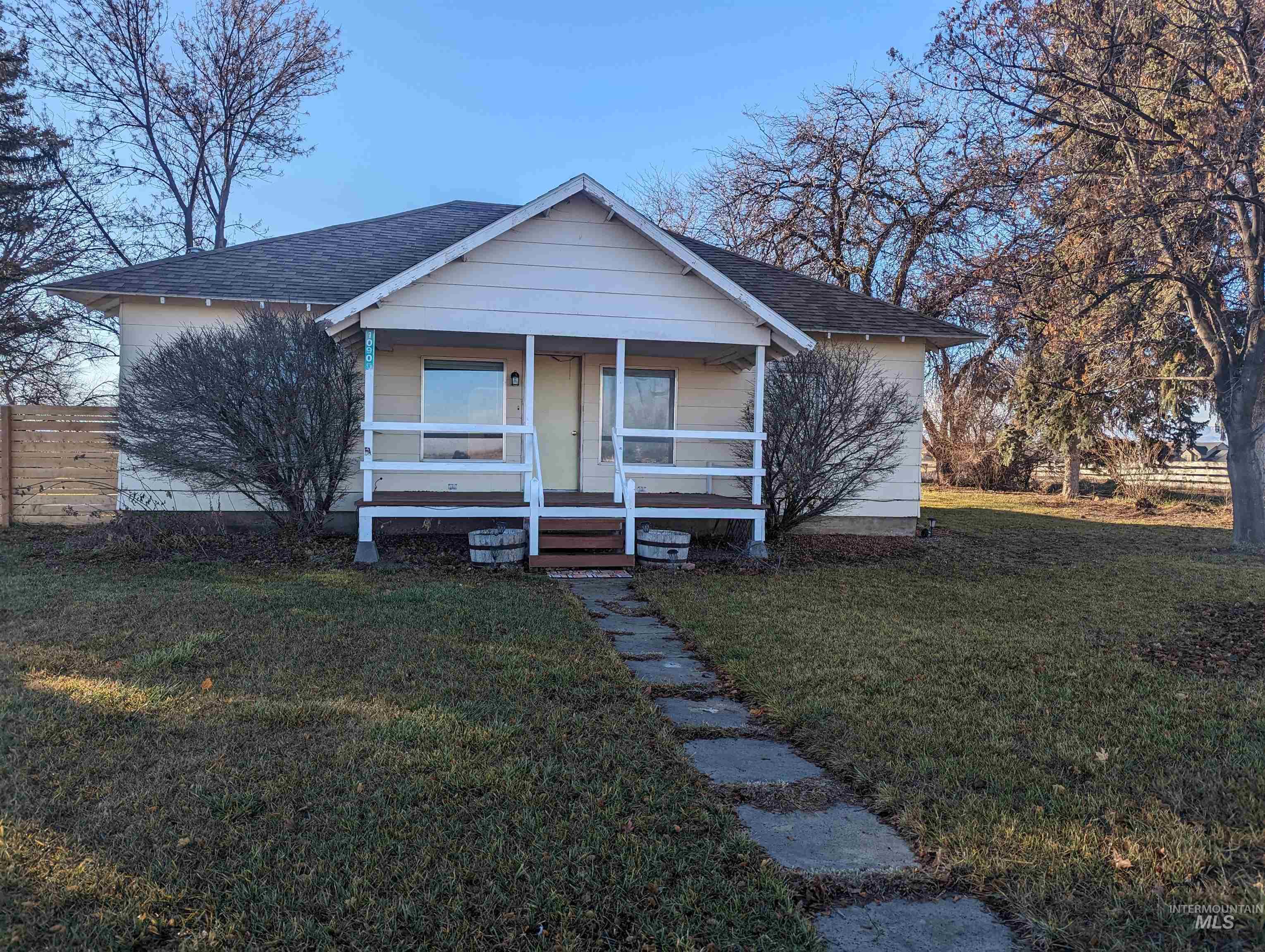 Bungalow with roof with shingles and a porch