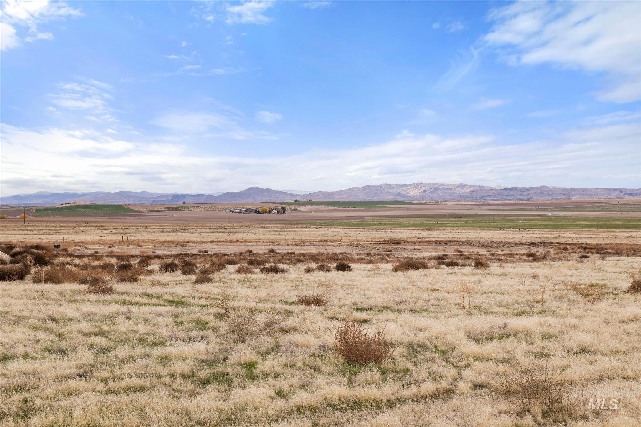 View of mountain backdrop with rural landscape