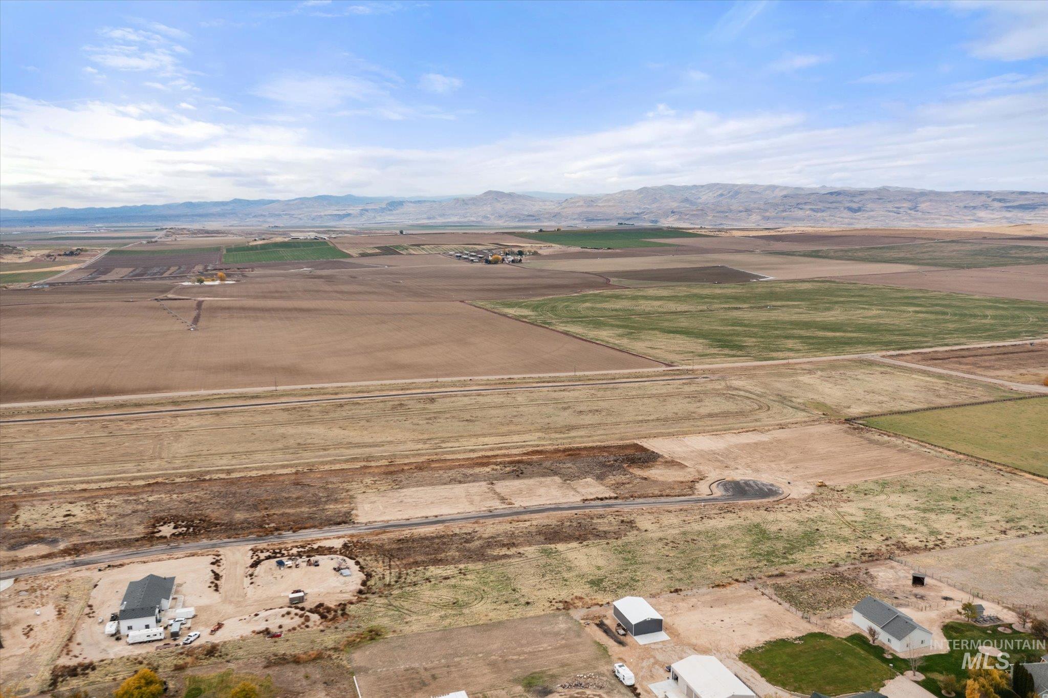 Aerial view of property's location featuring rural landscape and mountains