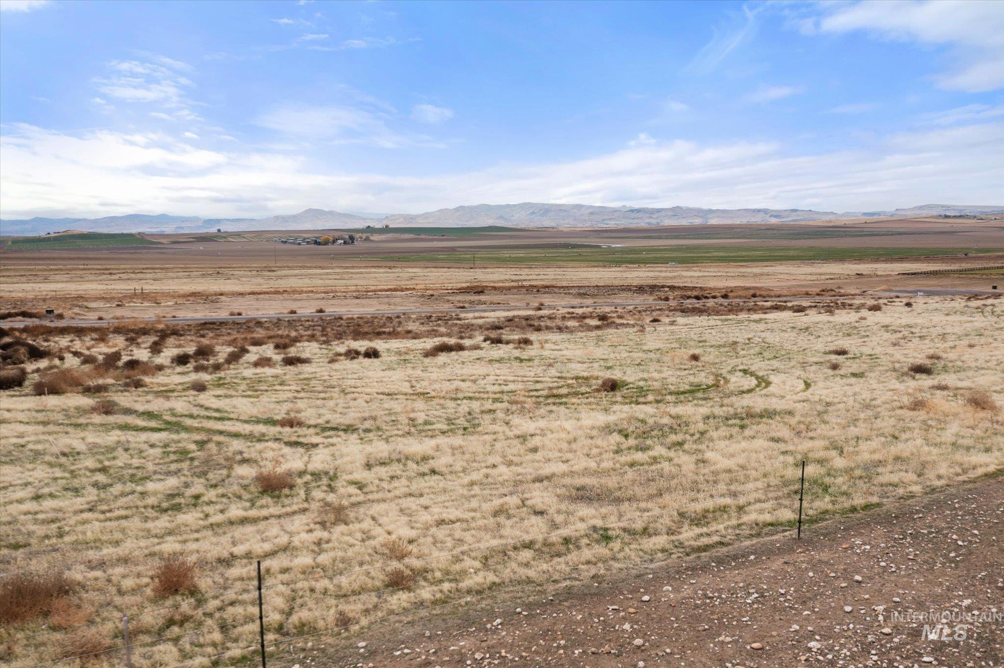 View of mountain backdrop with rural landscape and a desert landscape