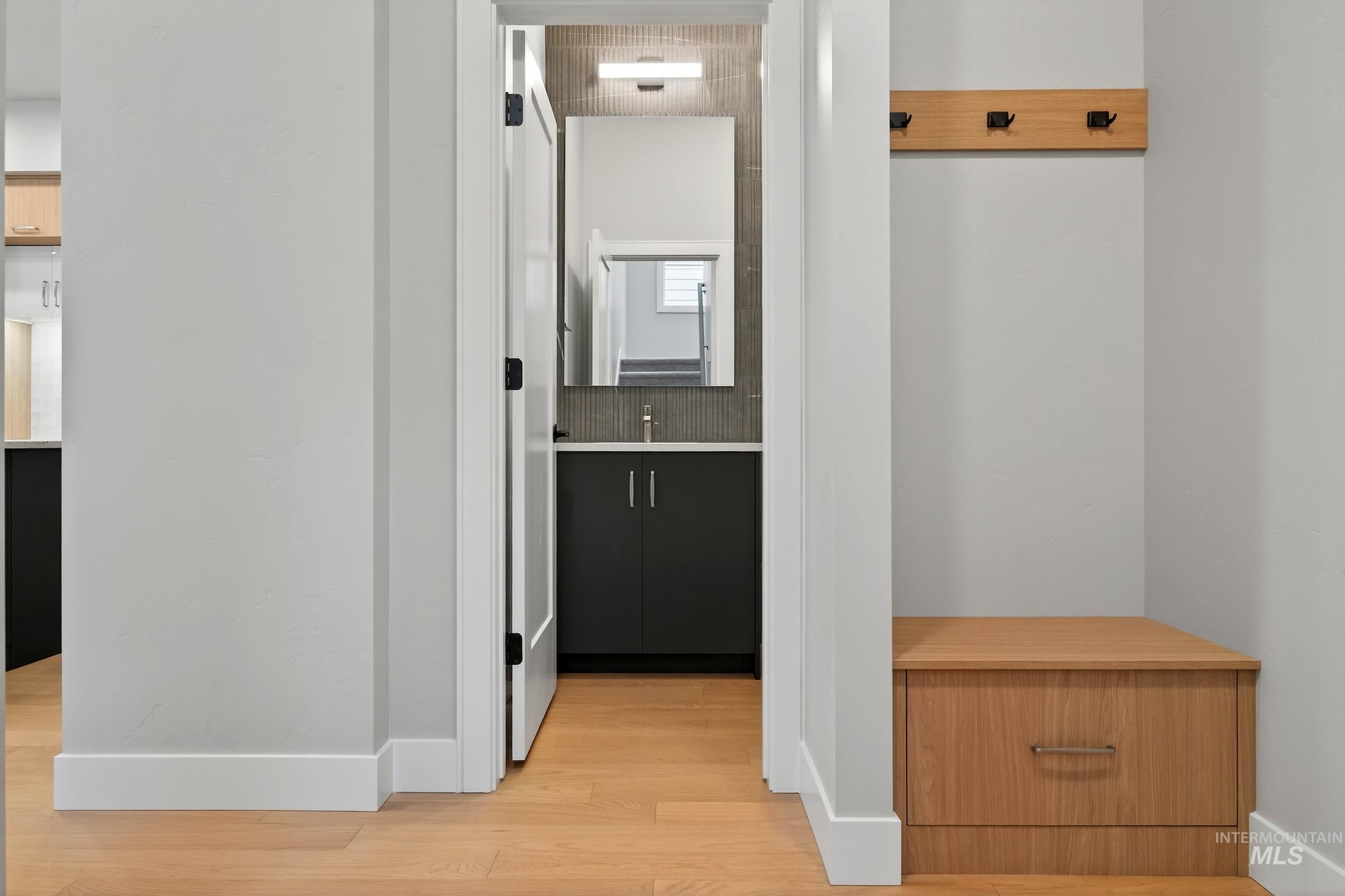 Hallway featuring light wood-style flooring and baseboards