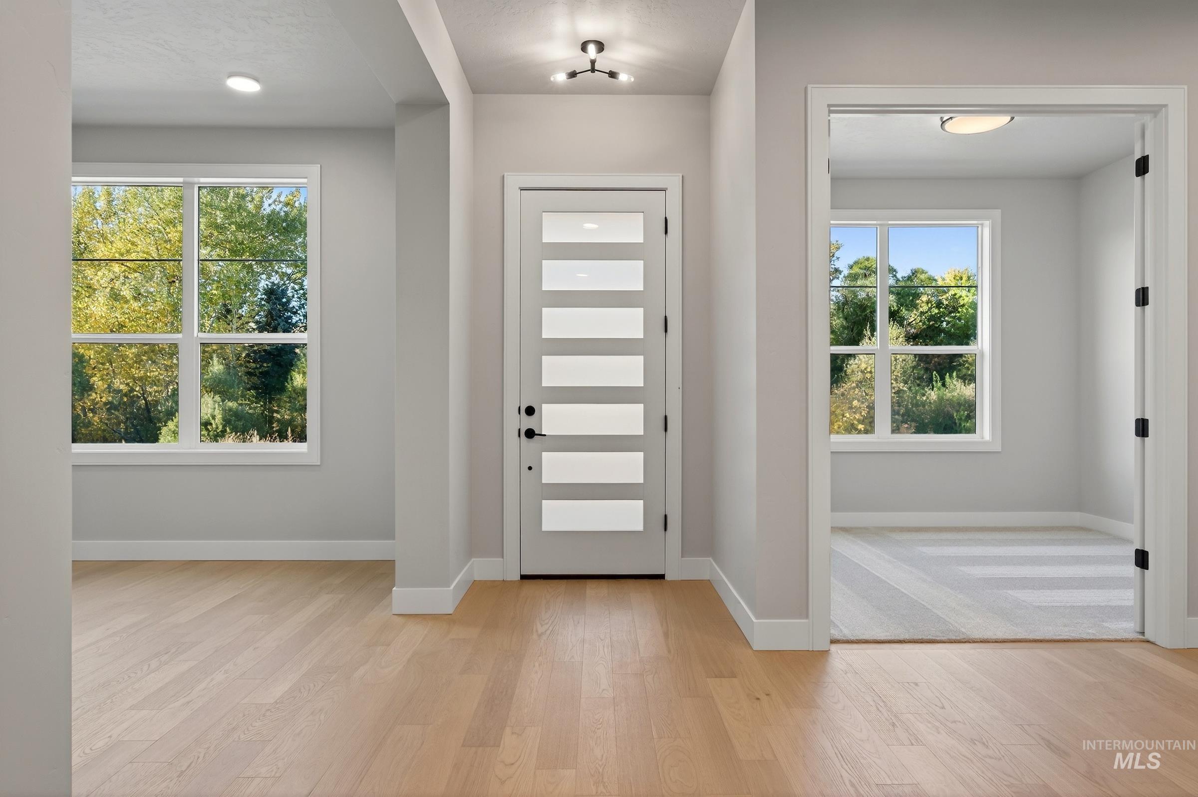 Foyer featuring light wood-type flooring and recessed lighting