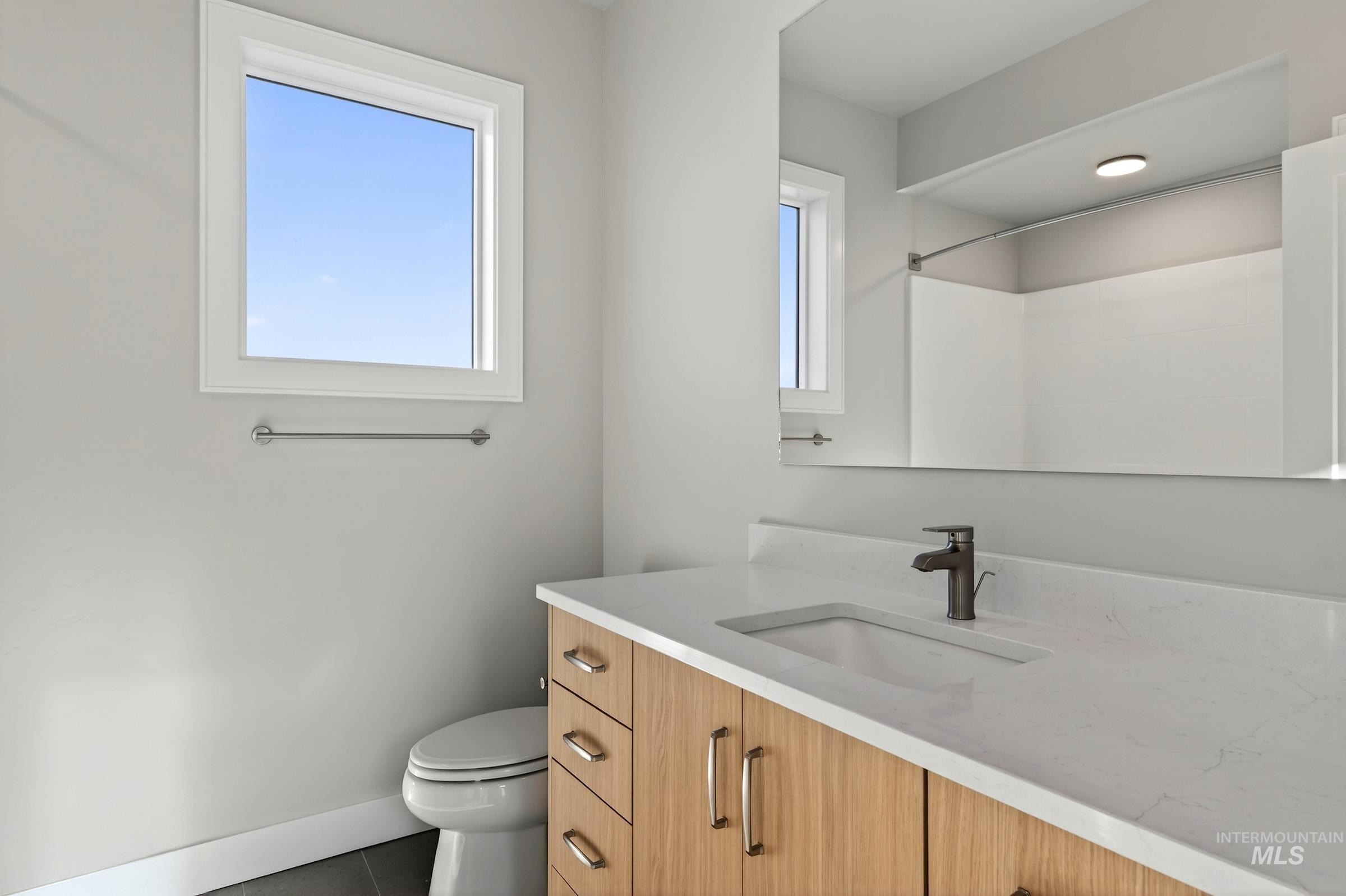 Full bathroom featuring vanity, tile patterned flooring, and a shower