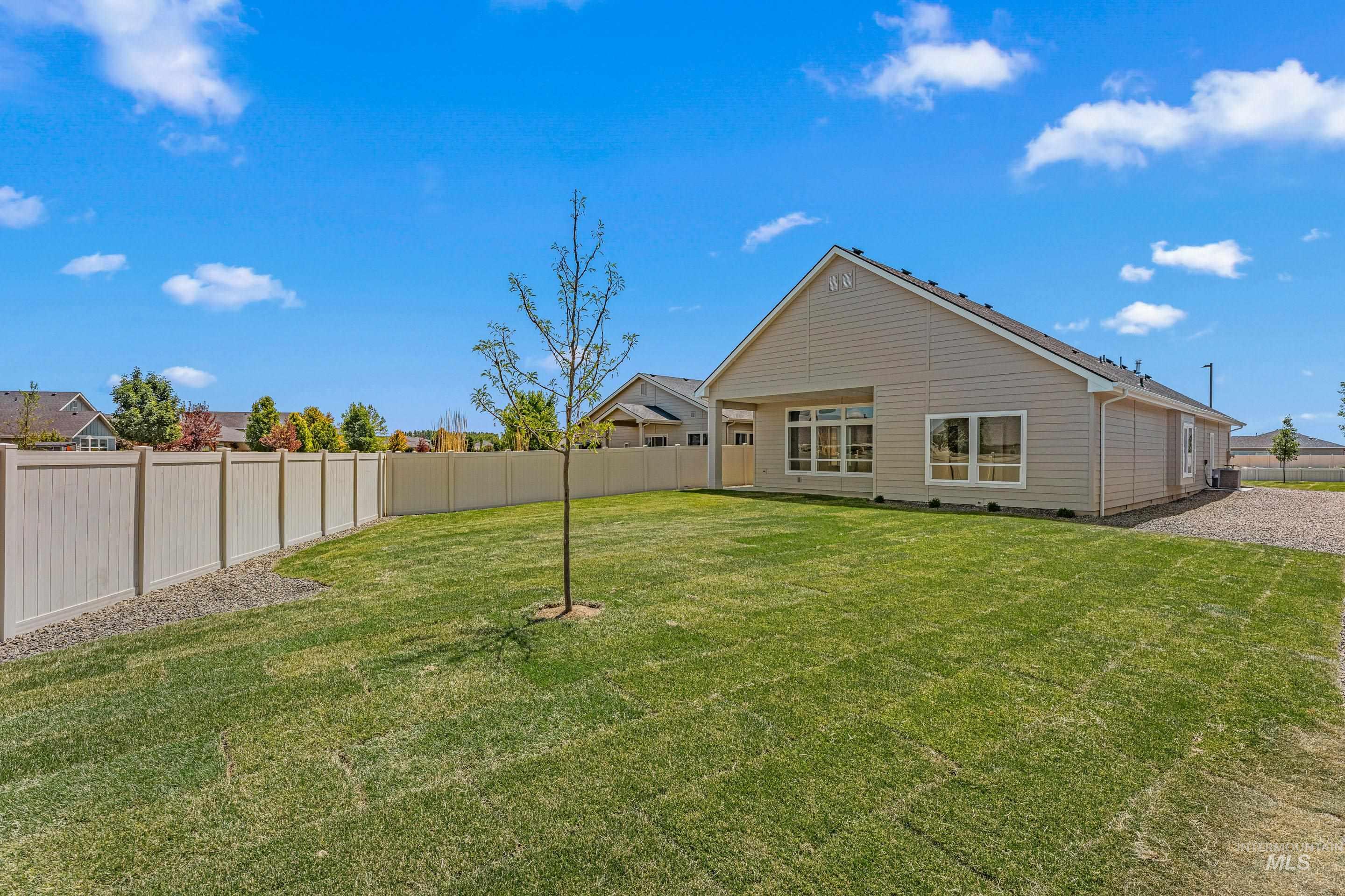 Rear view of house with a fenced backyard