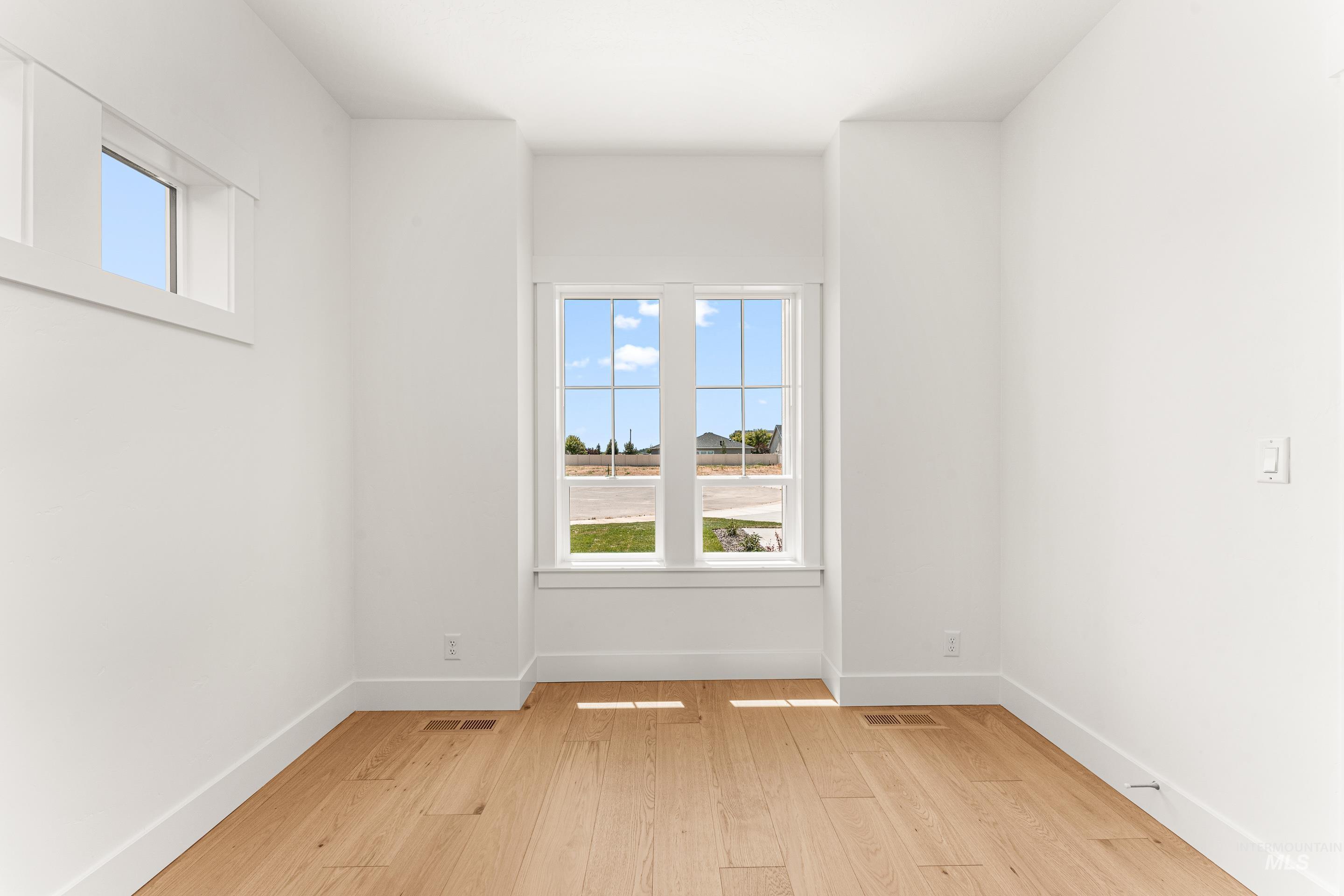 Unfurnished room featuring plenty of natural light and light wood-style floors