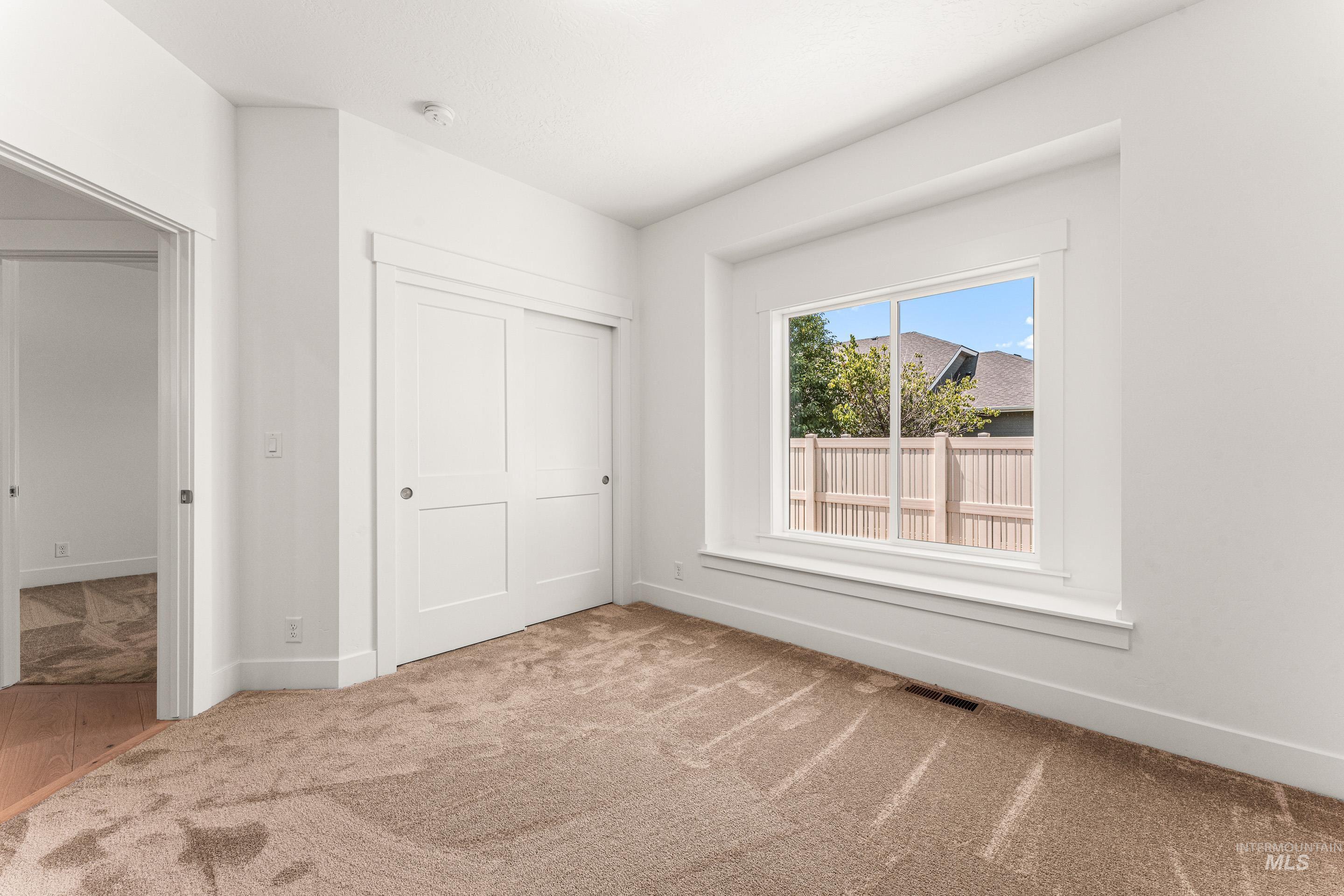 Unfurnished bedroom with carpet floors and a closet