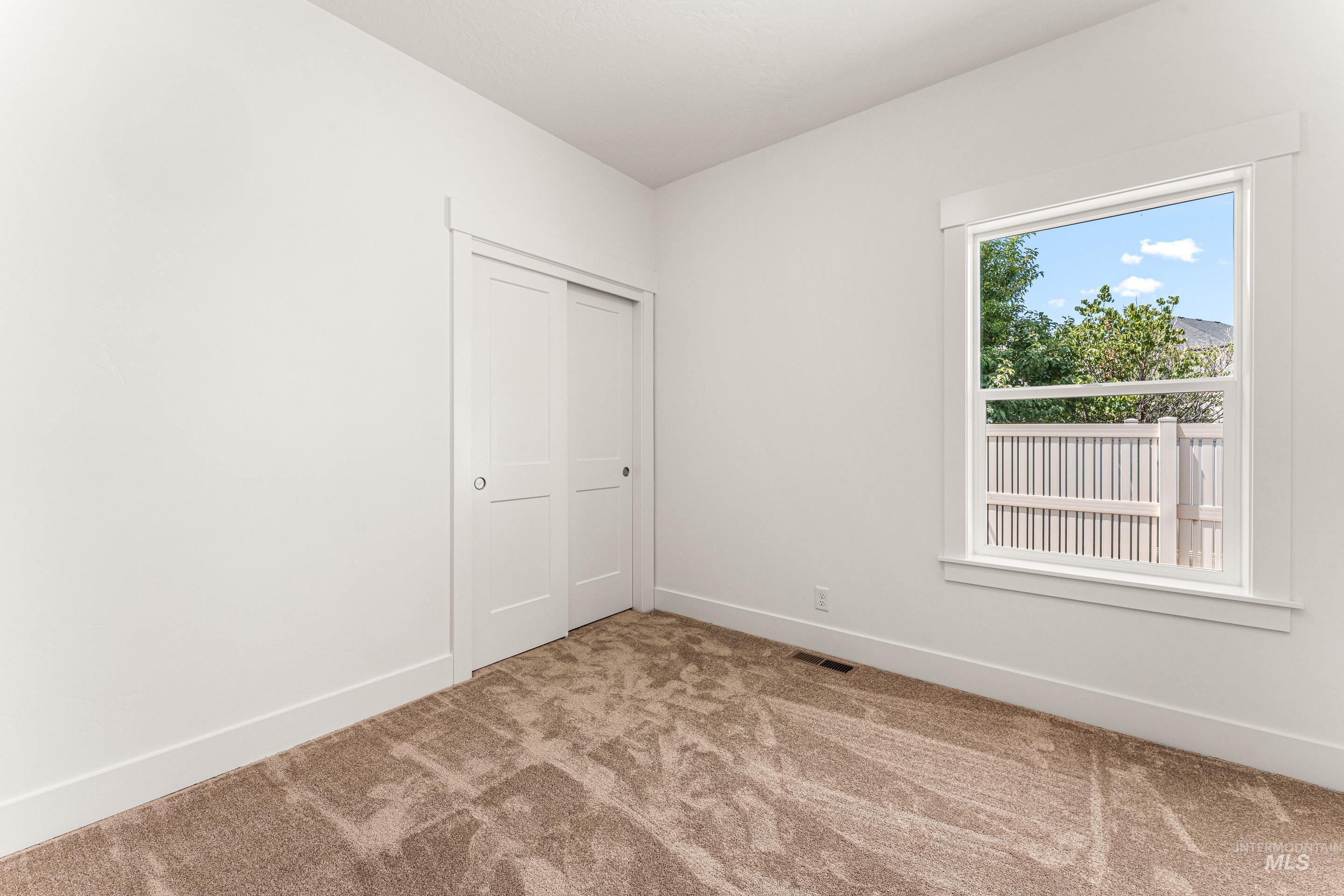 Unfurnished bedroom featuring carpet flooring and a closet