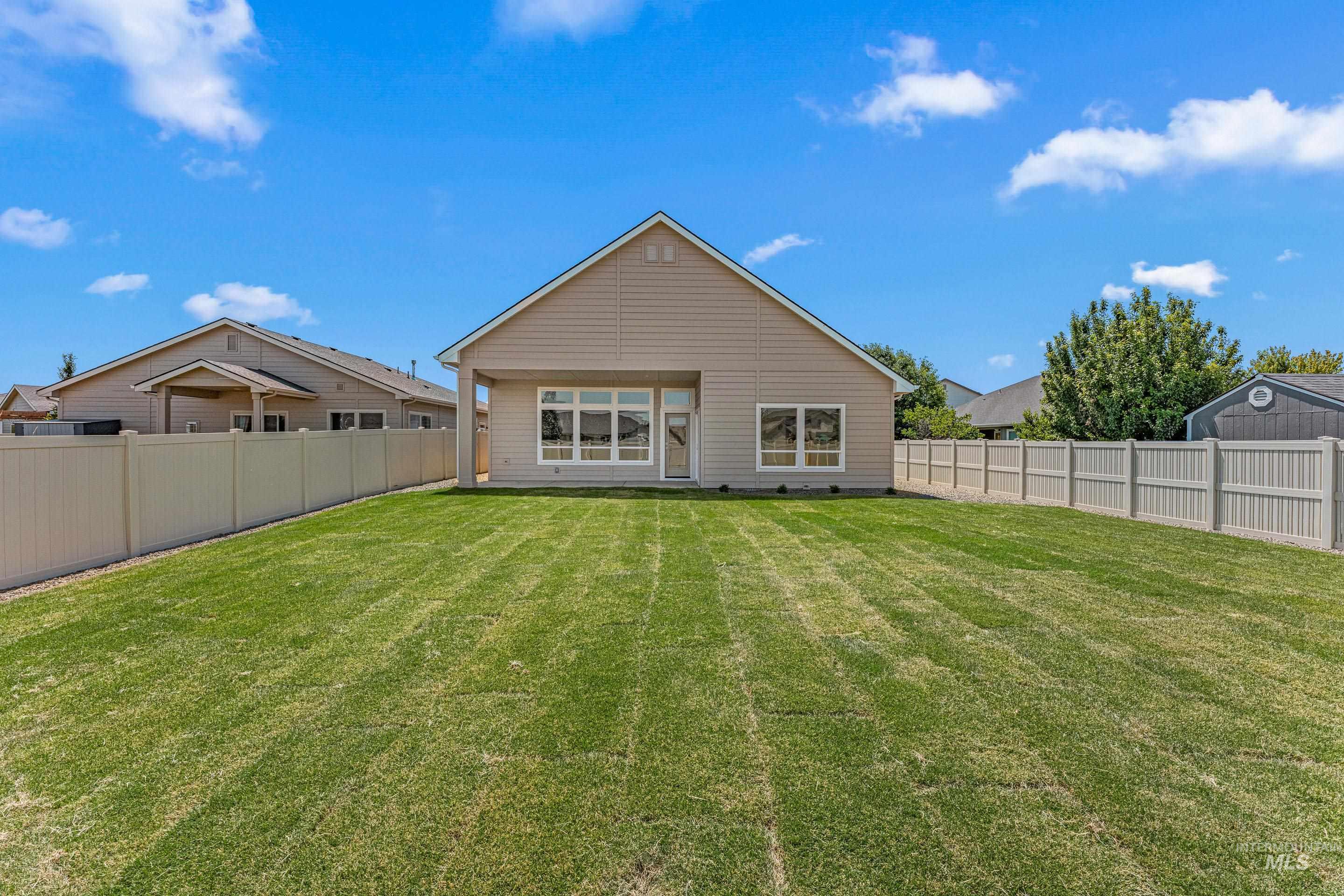 Back of property featuring a fenced backyard