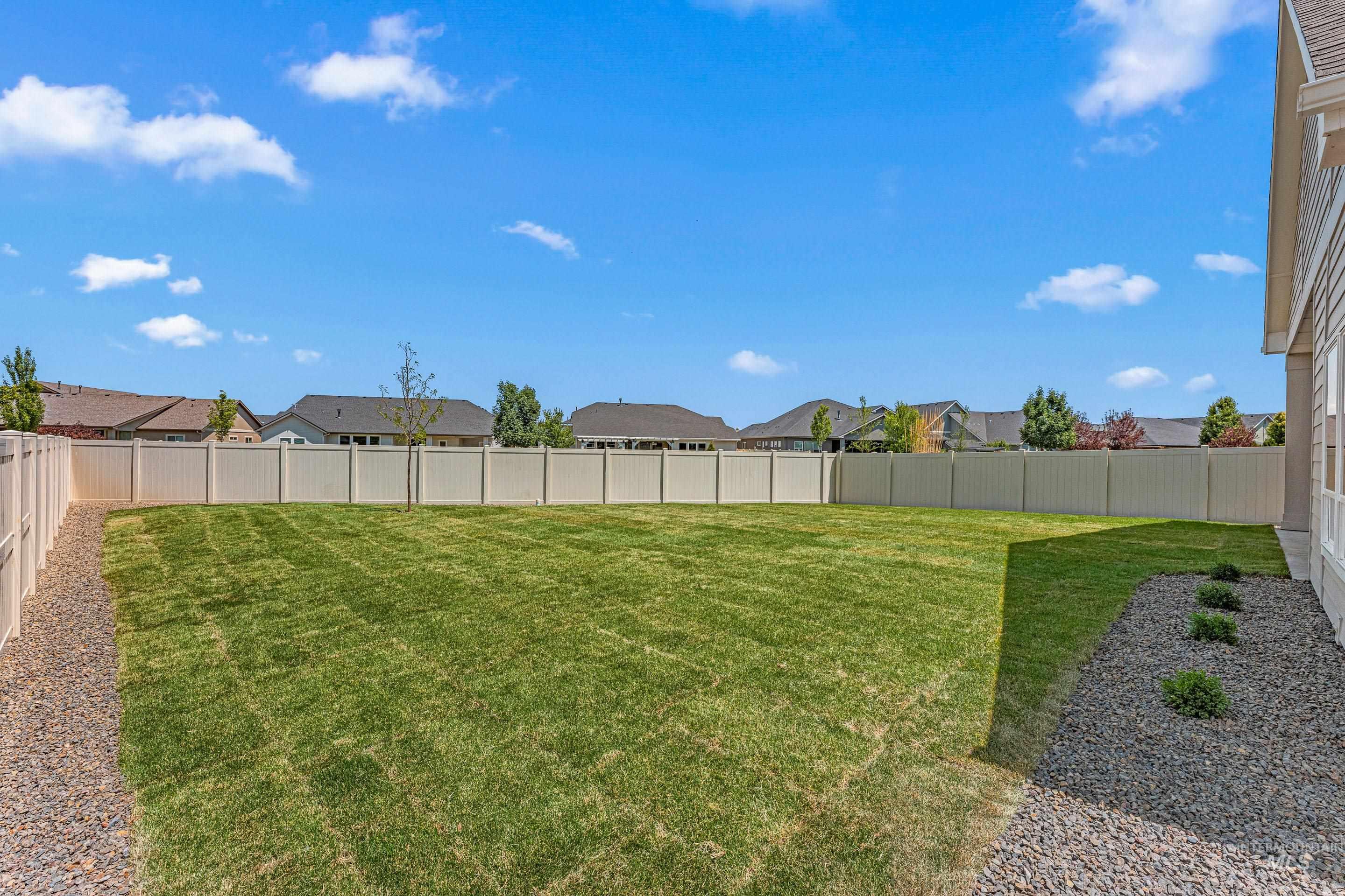 Fenced backyard with a residential view
